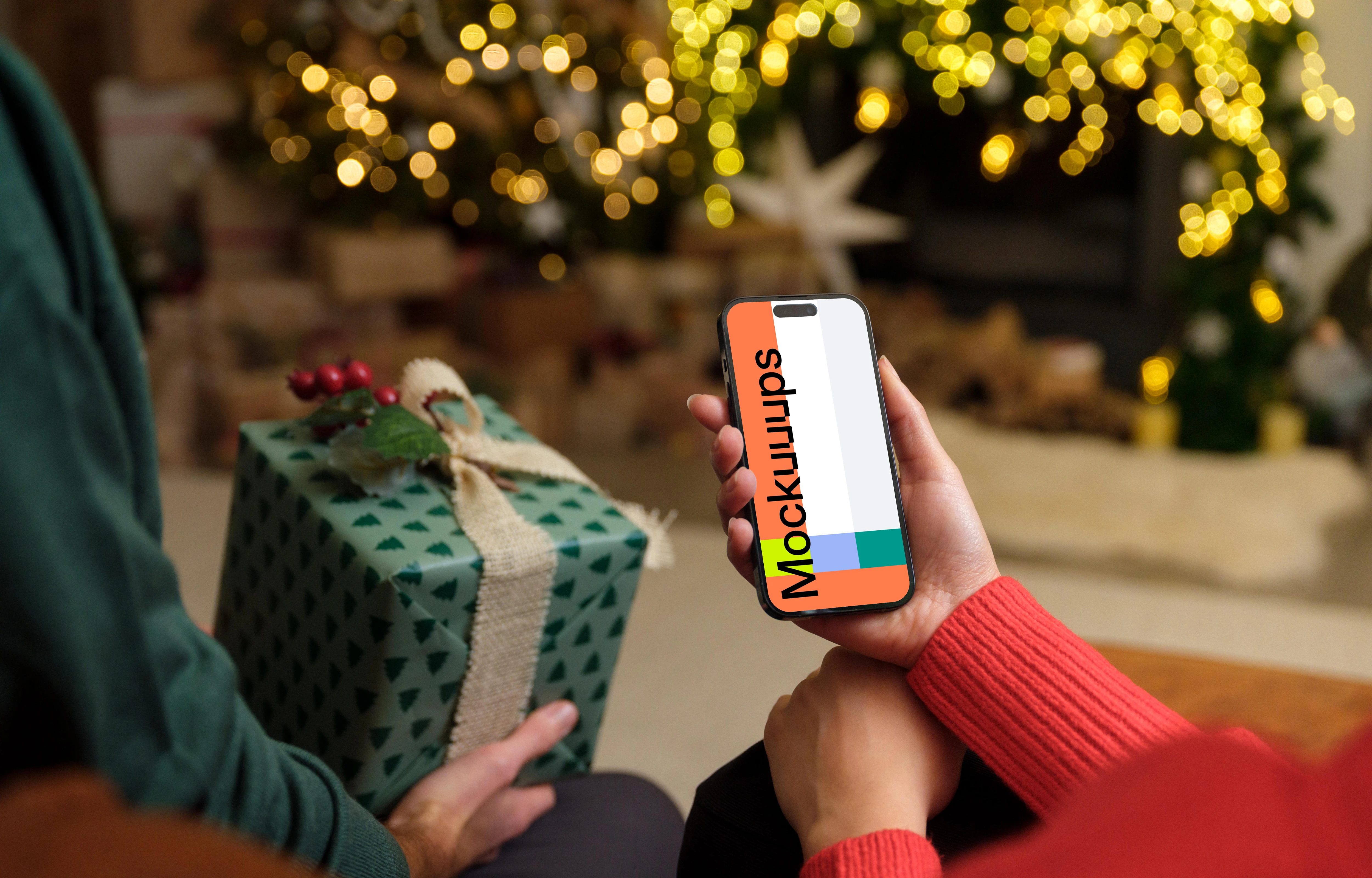 Person in red sweater holding a phone mockup
