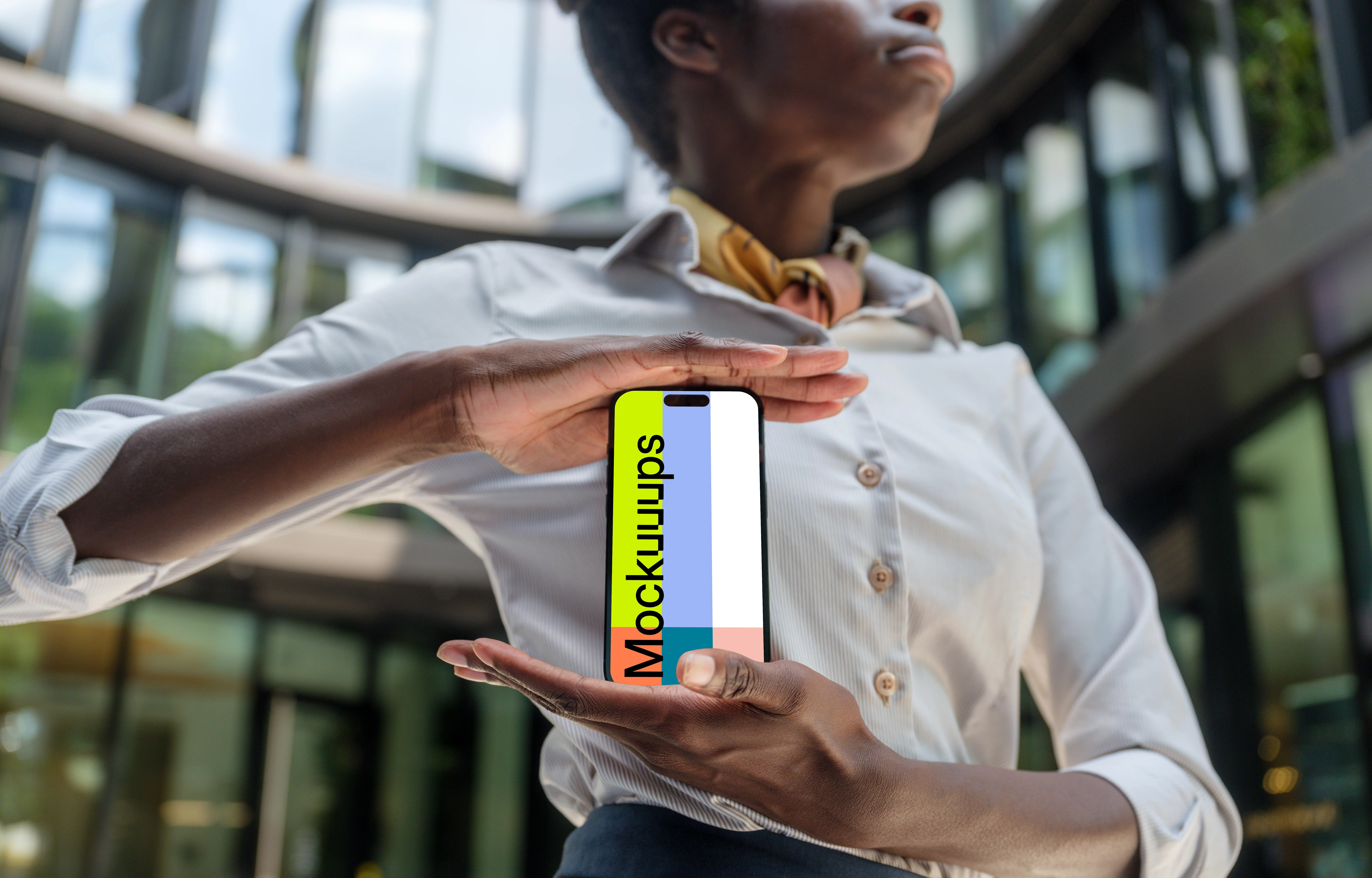 Female entrepreneur standing in front of company with an iPhone