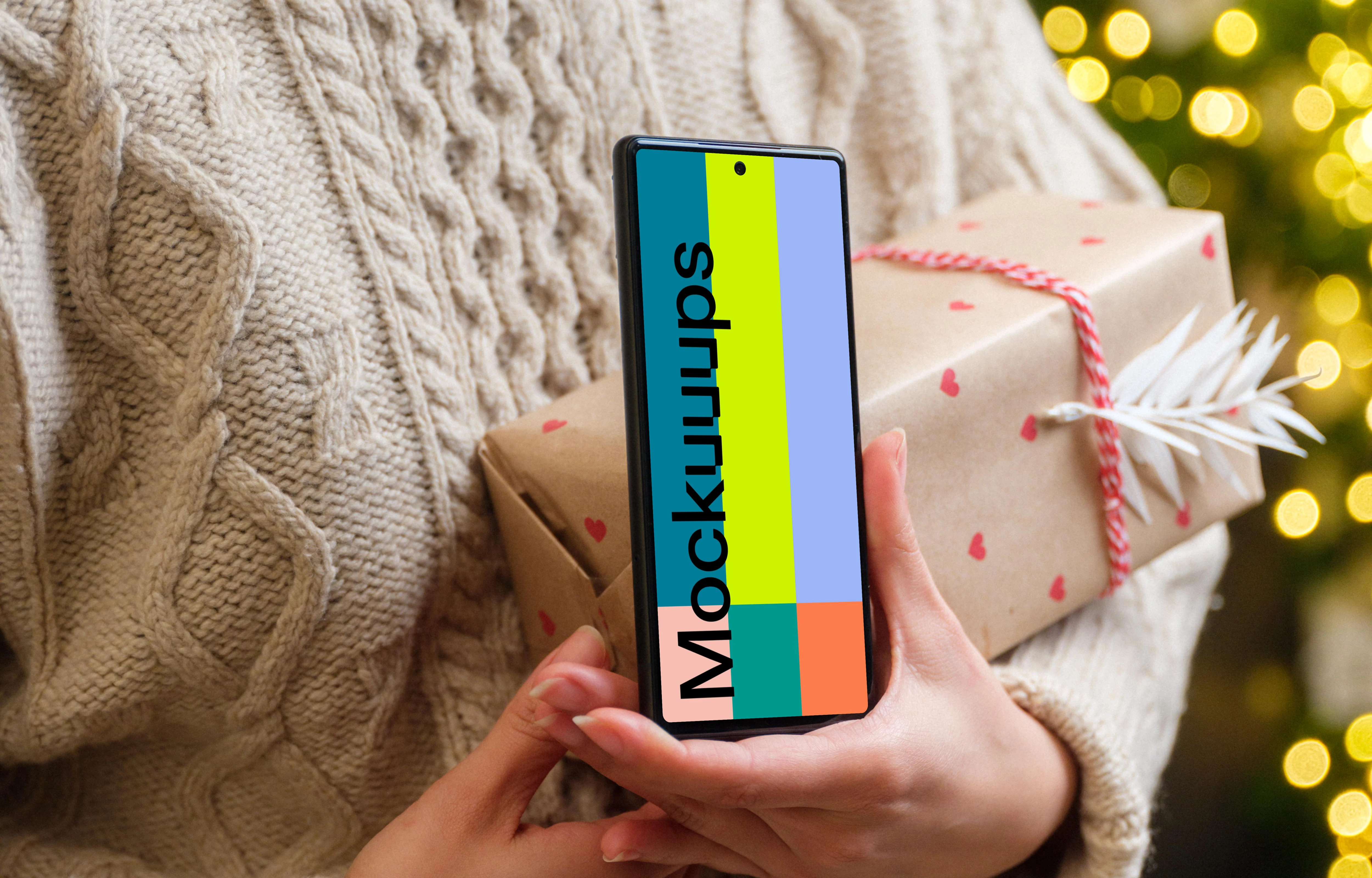 Female holding a Google Pixel and Christmas present mockup