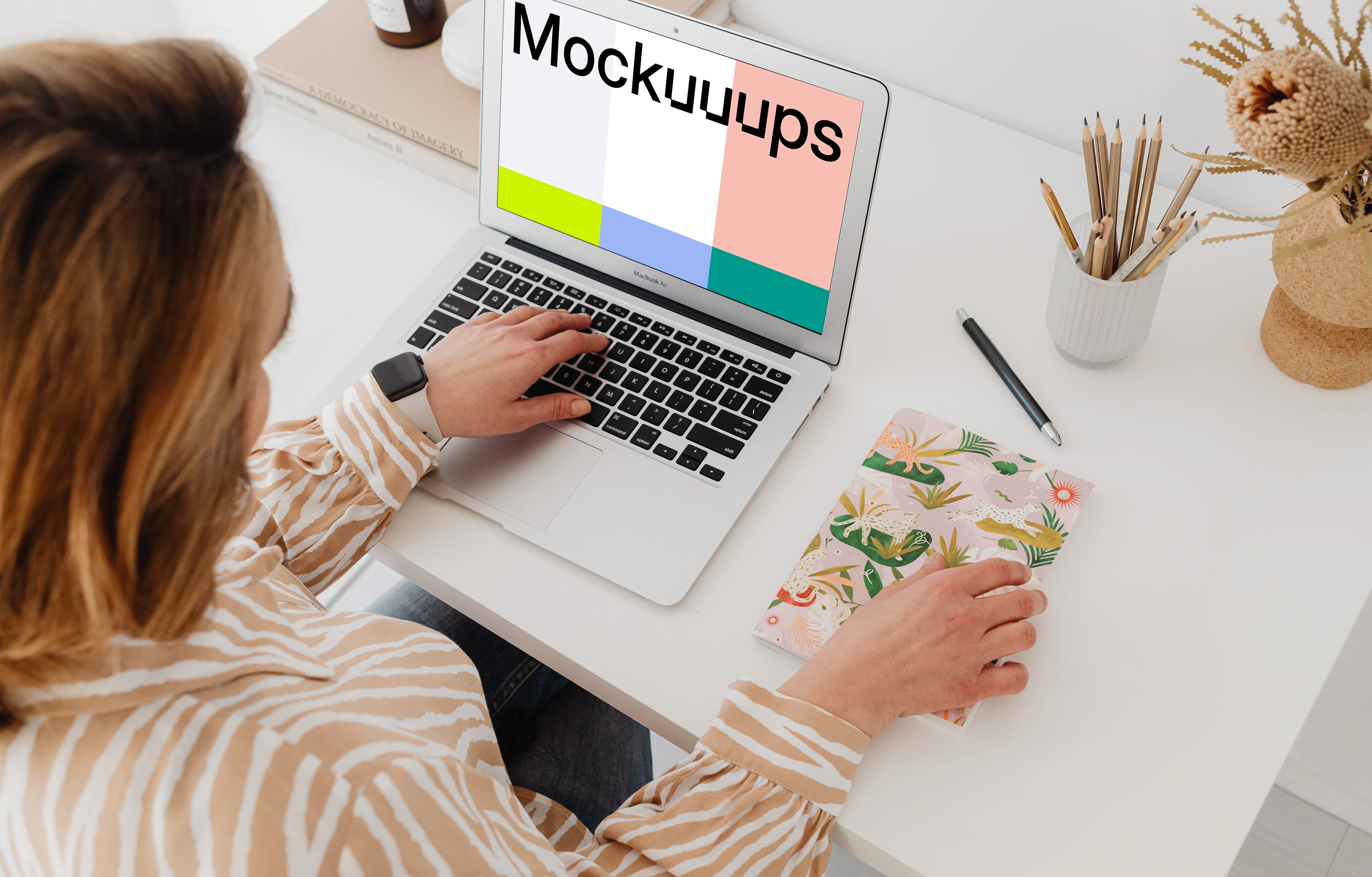 Female working on a MacBook Air mockup