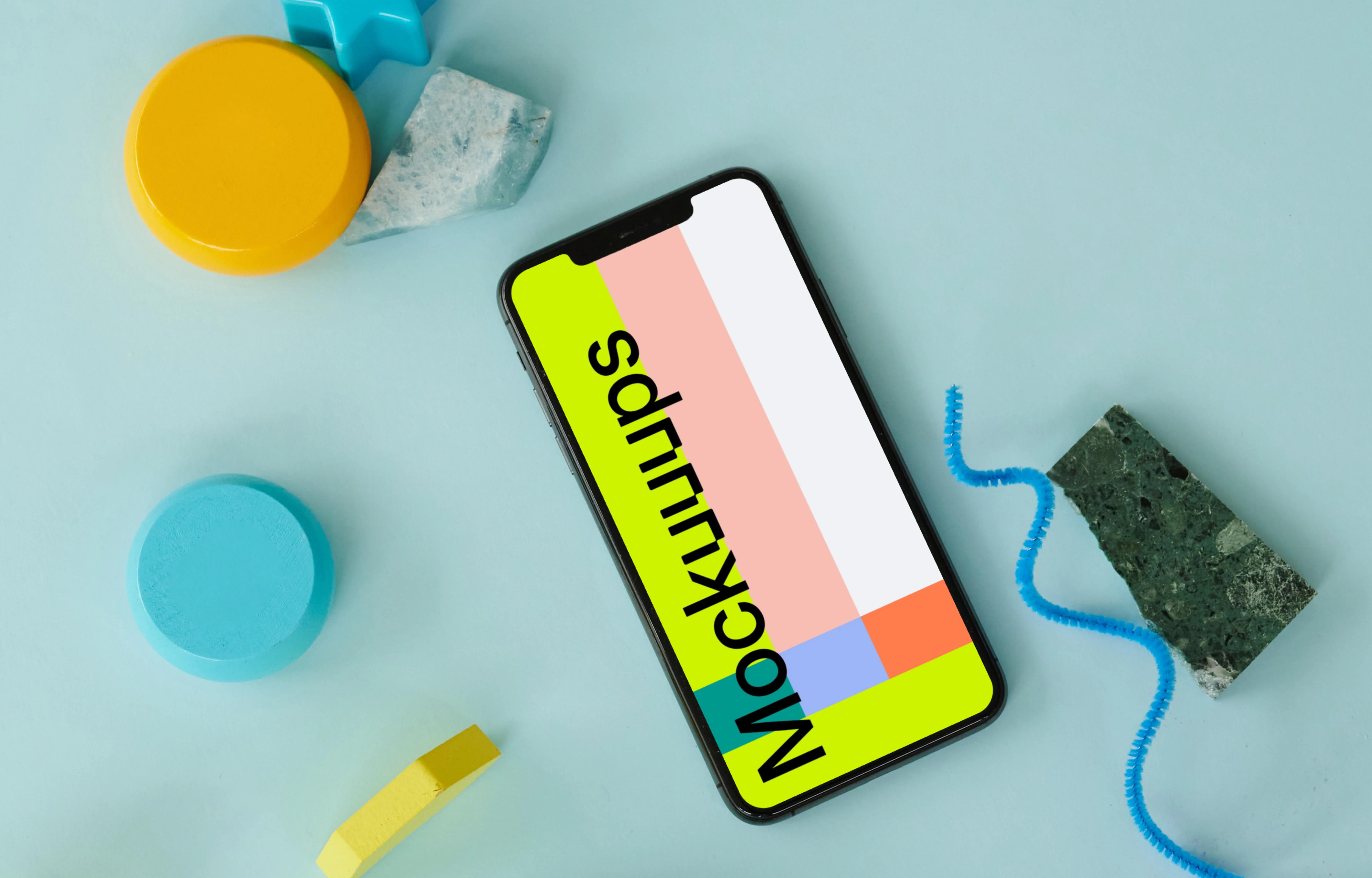 iPhone mockup on a blue table beside a pair of ebuds