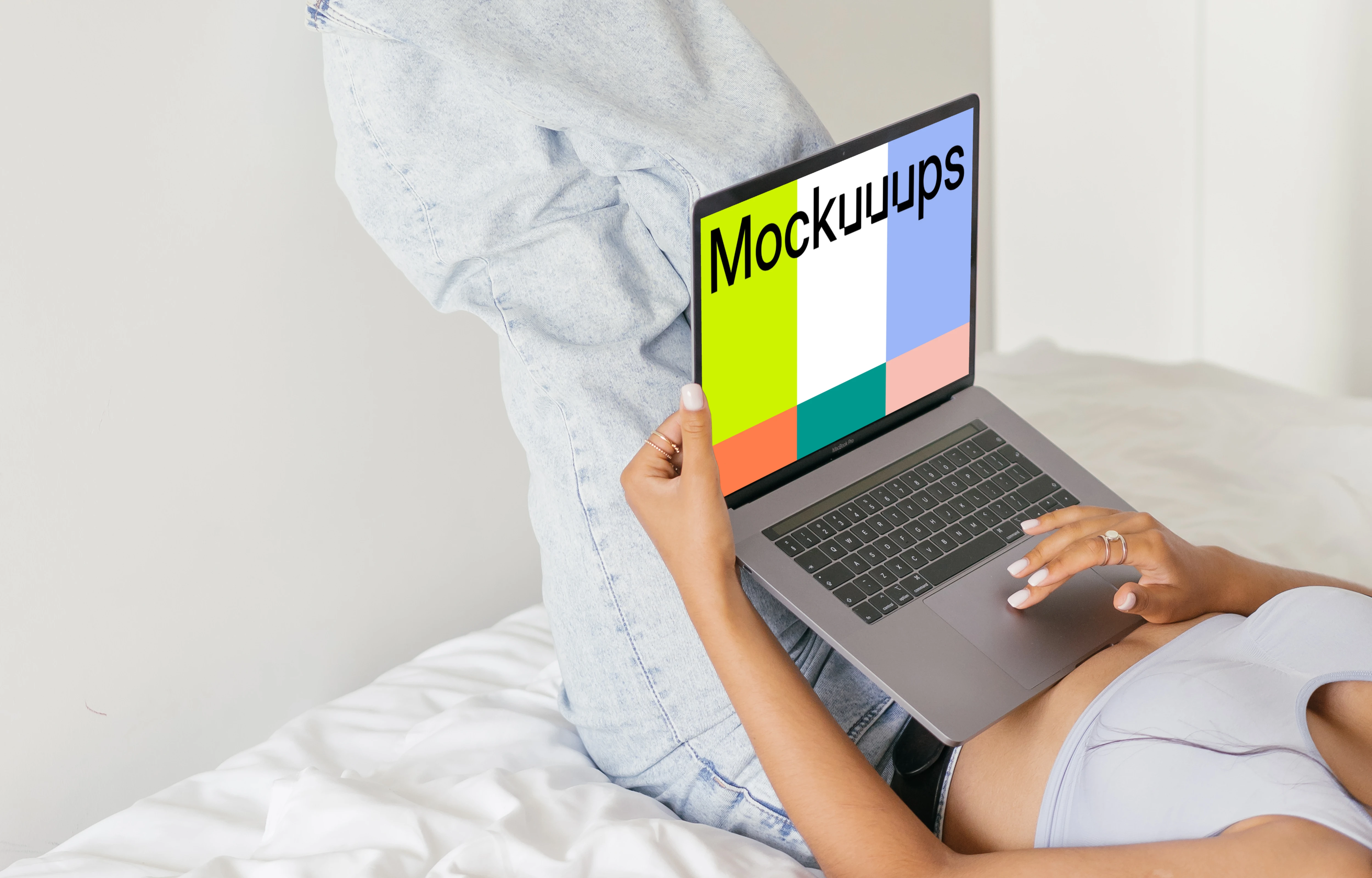 Grey MacBook Air mockup held in a user’s lap