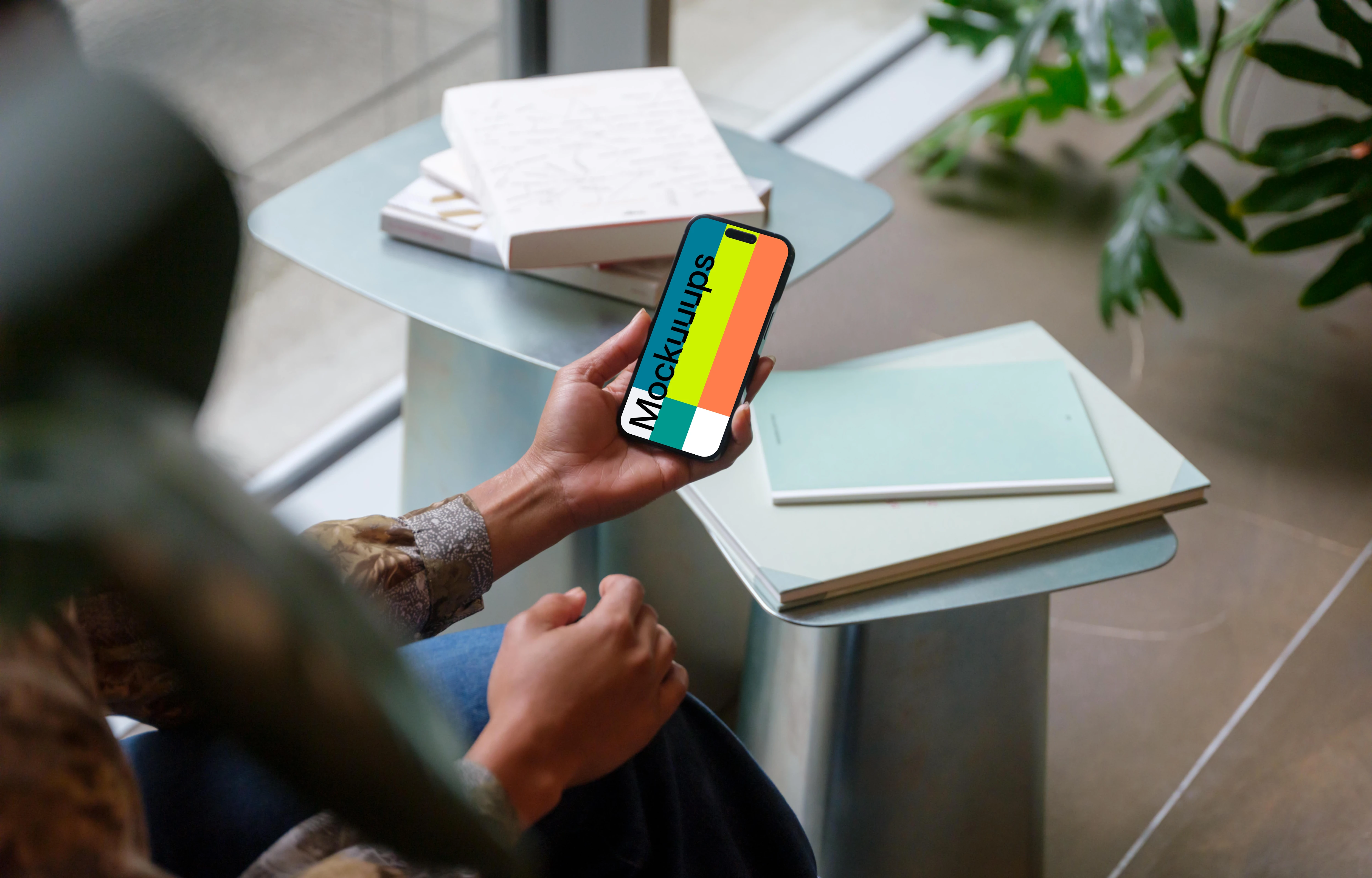 Hand holding an iPhone 14 Pro mockup