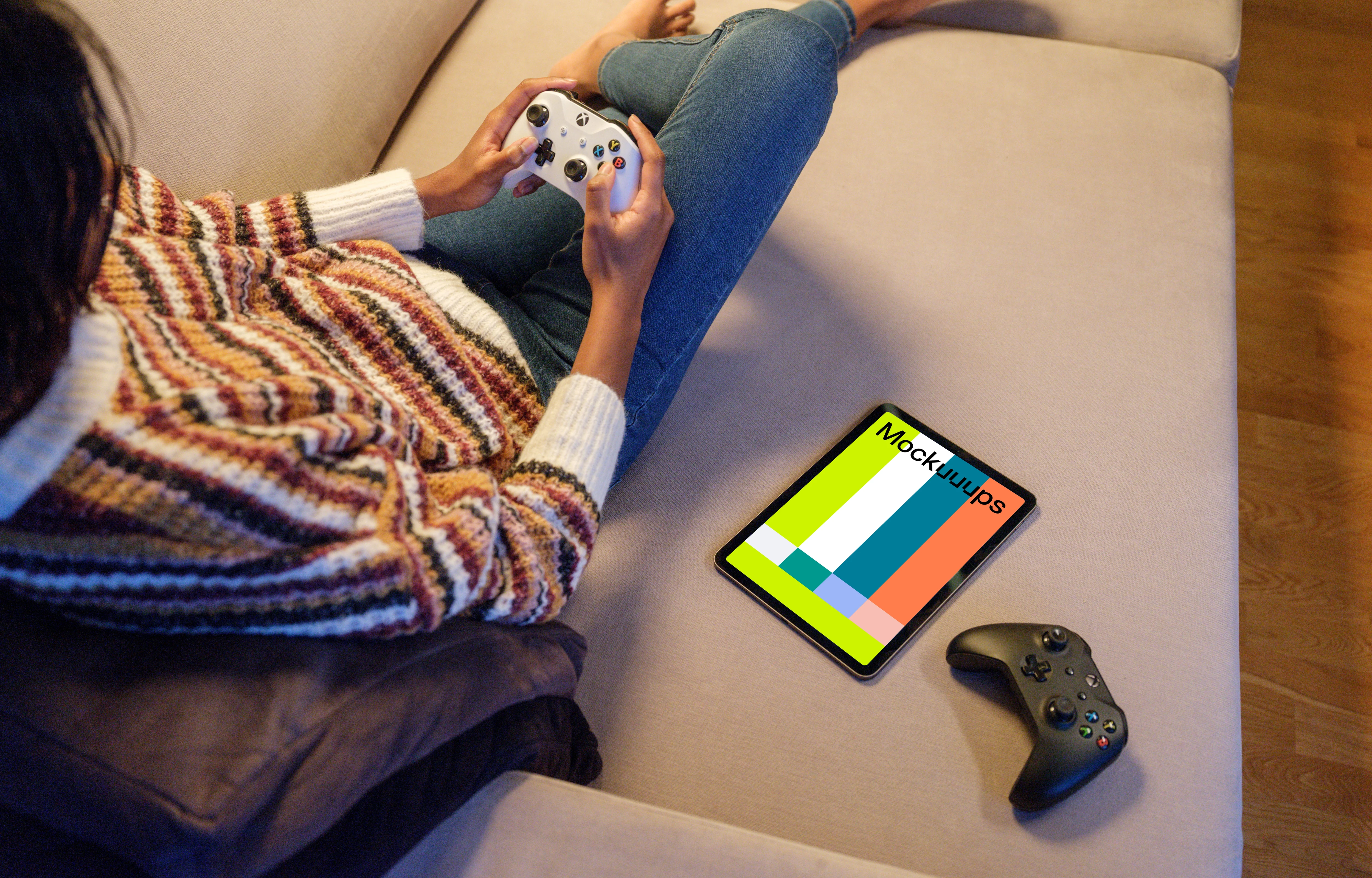 iPad Air mockup with gaming controllers on a sofa