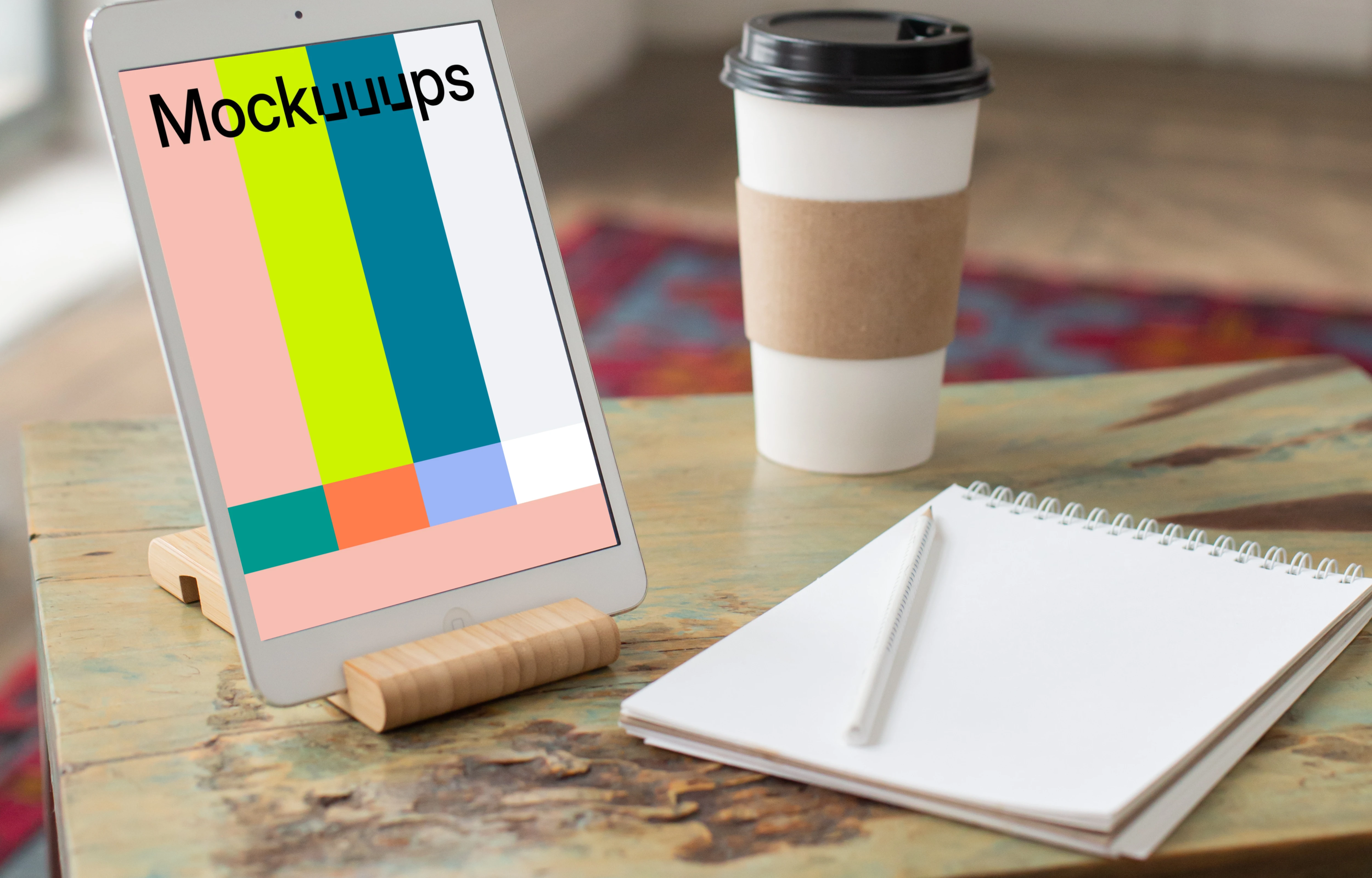 iPad Mini mockup beside a notepad