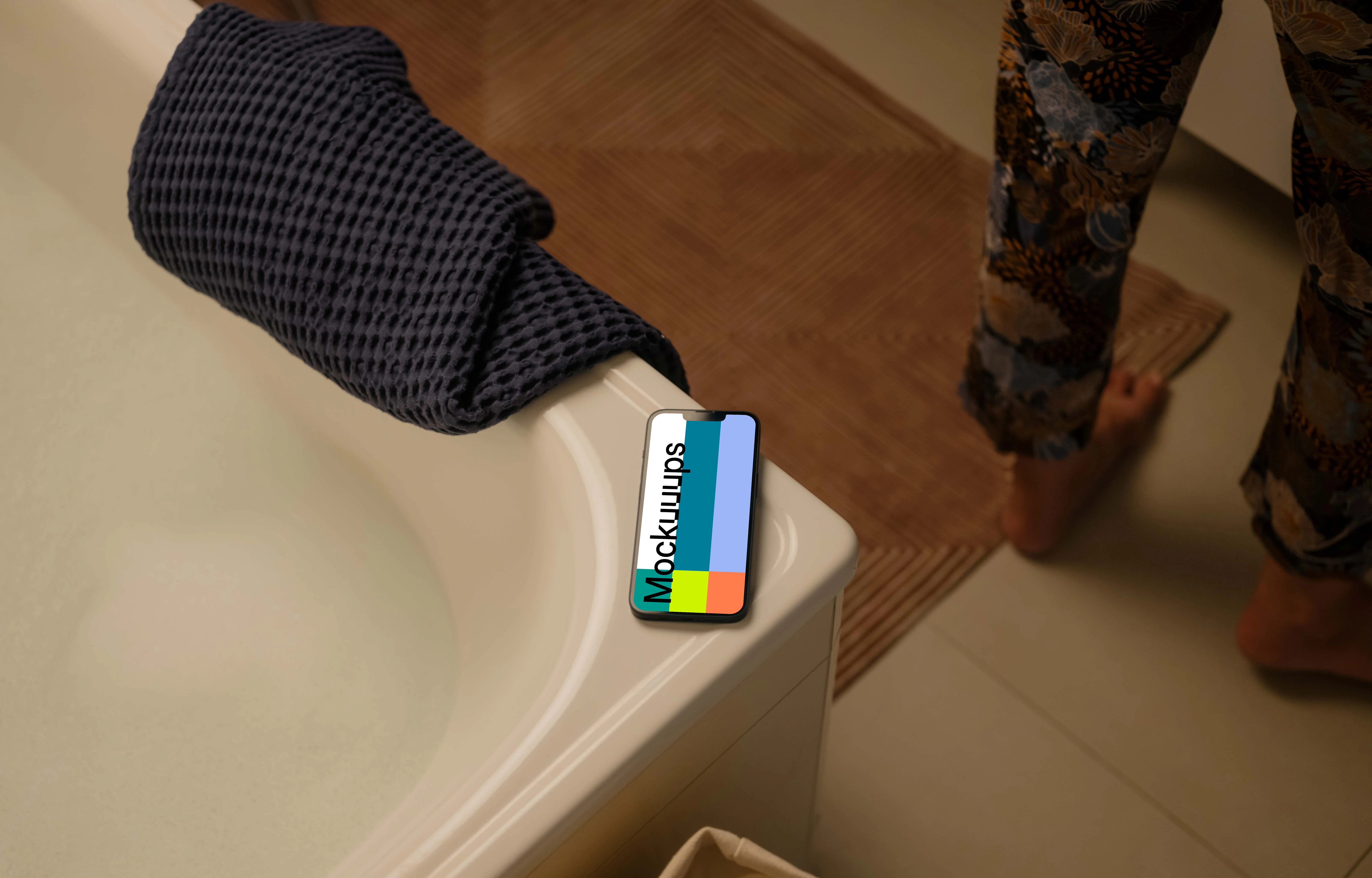 iPhone 13 mockup on an edge of a bathtub