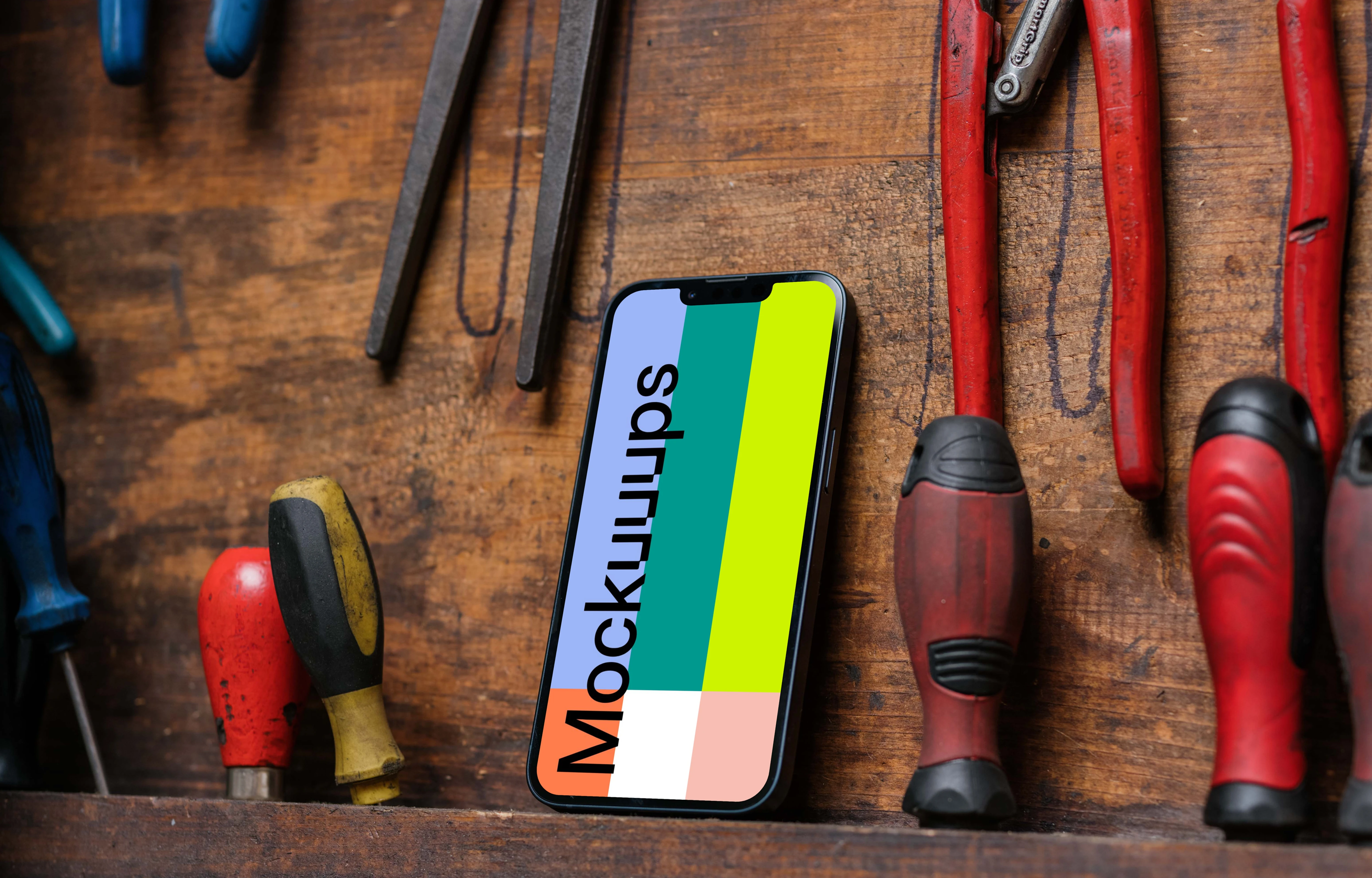 iPhone 13 Pro mockup beside work tools