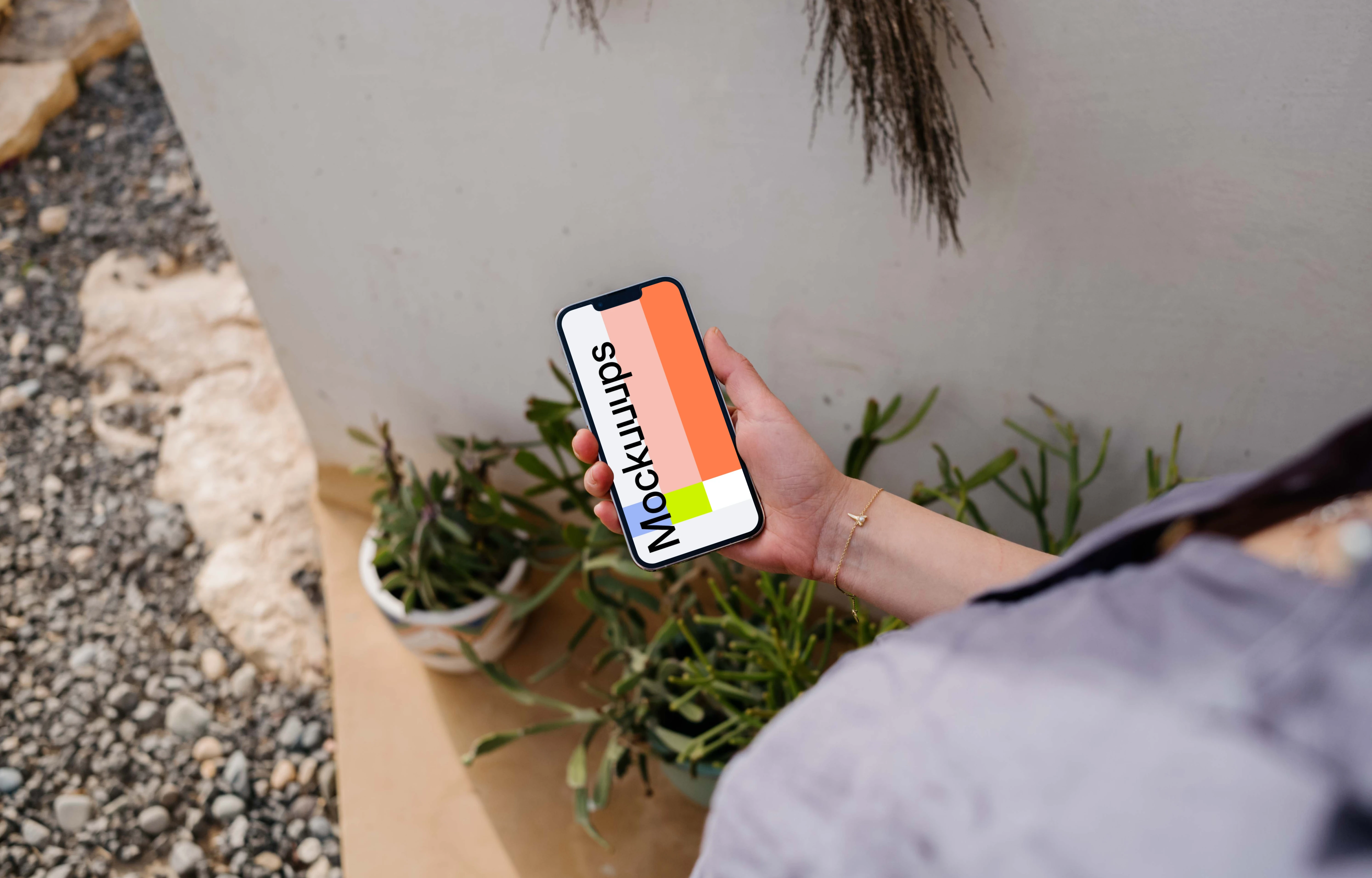 iPhone 13 Pro mockup held by a user outdoors