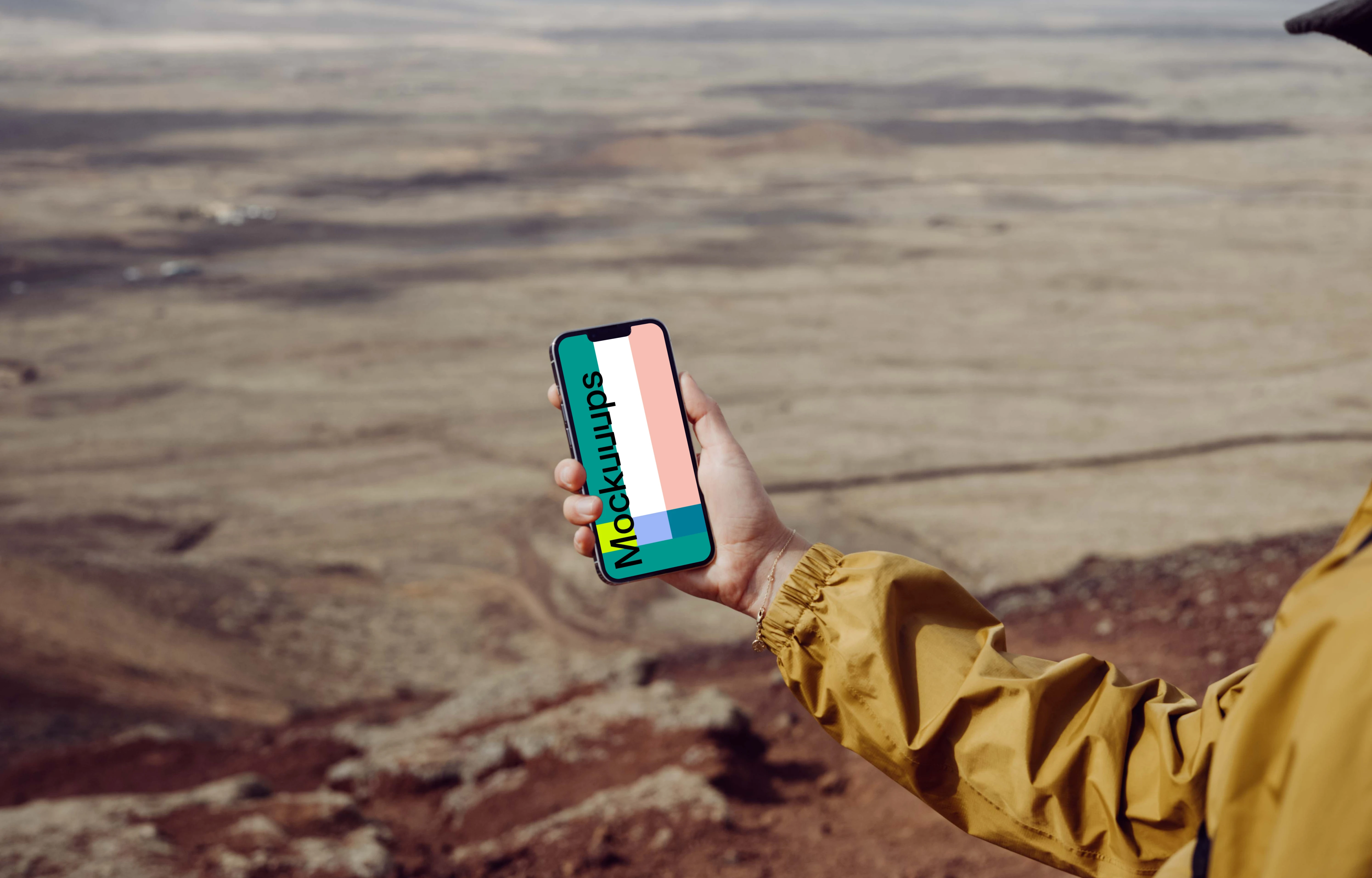 iPhone 13 Pro mockup held by a user over a large field