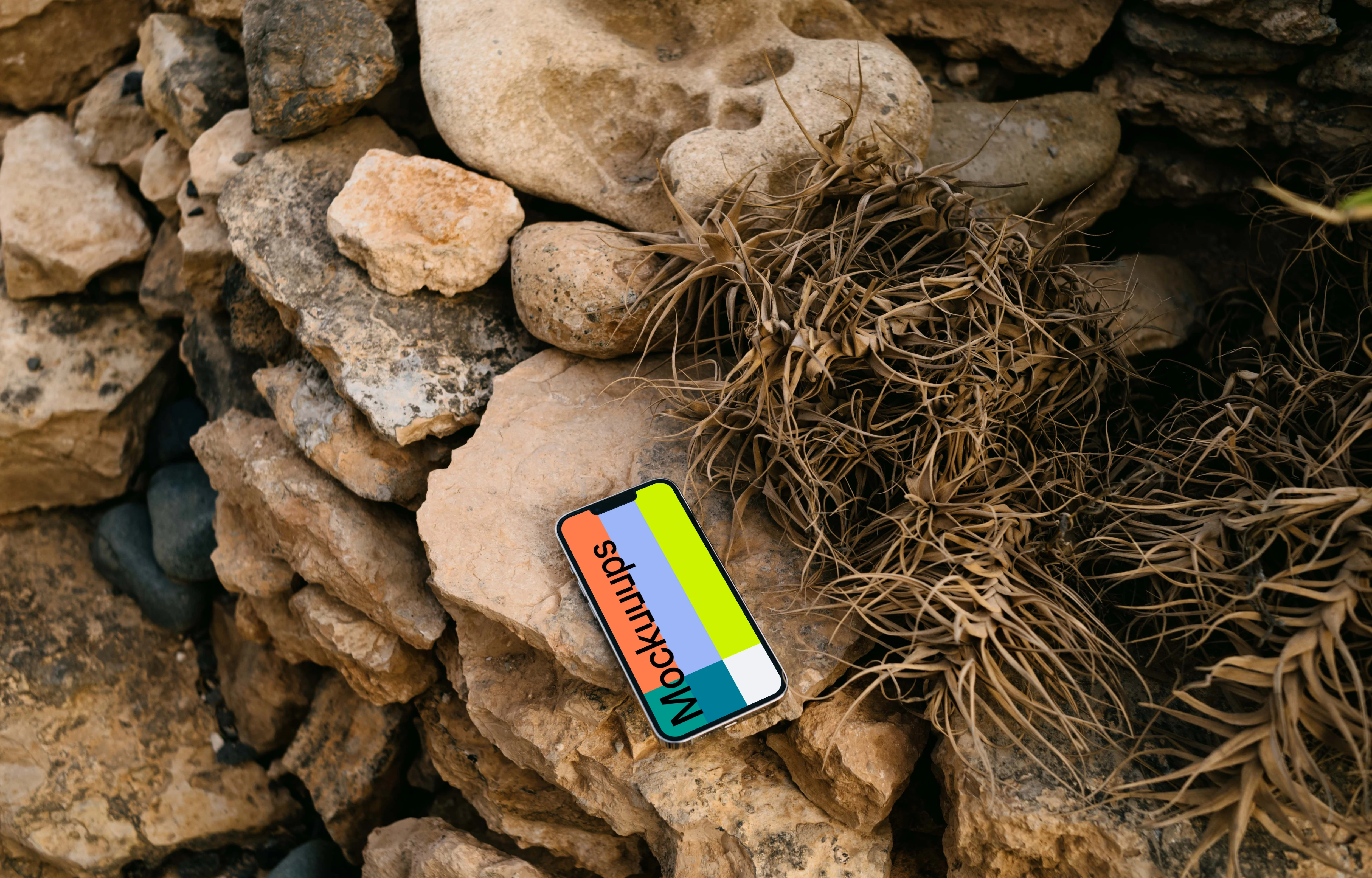 iPhone 13 Pro mockup on stacked rocks