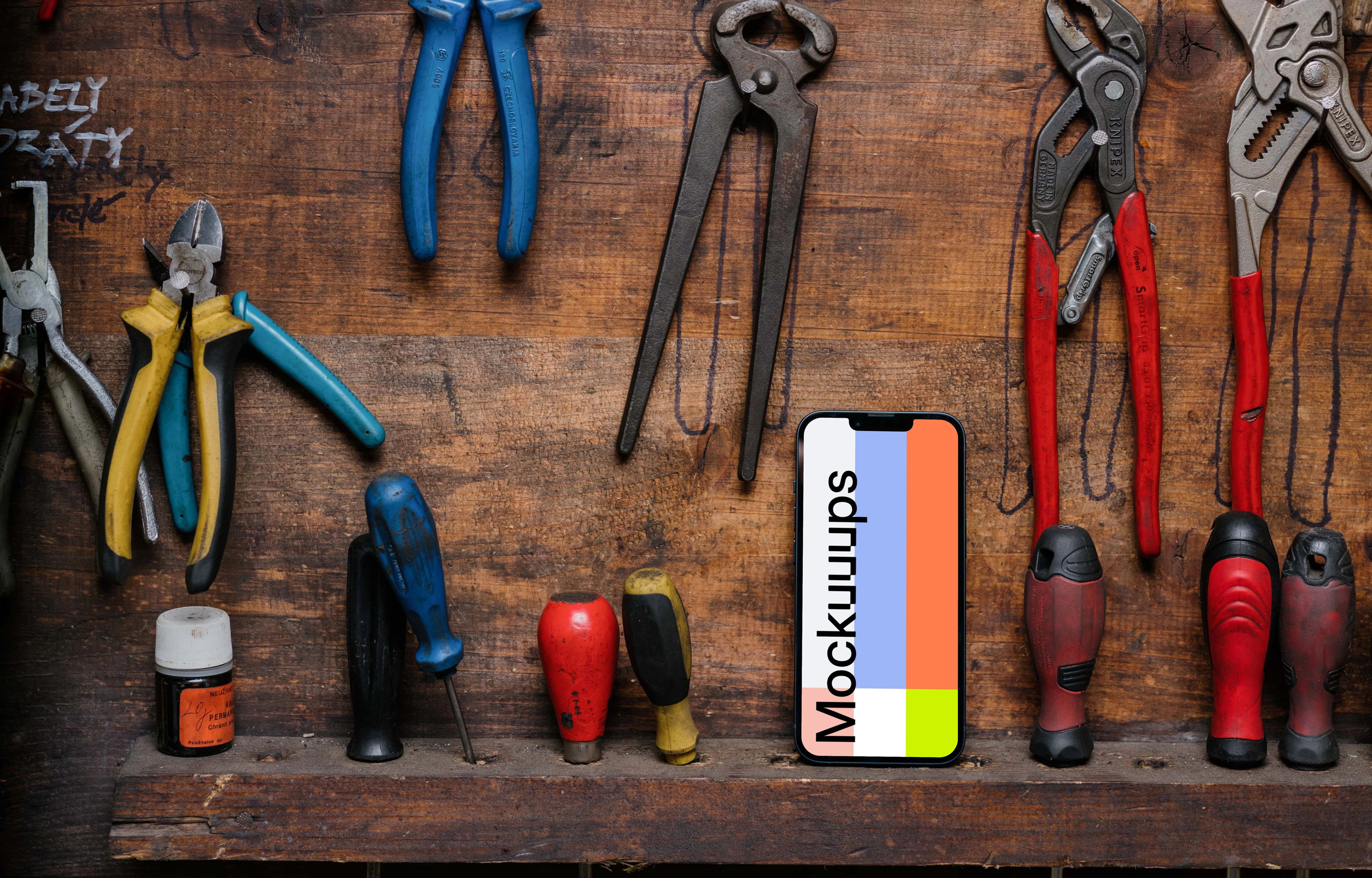 iPhone 13 Pro mockup placed next to a couple of tools