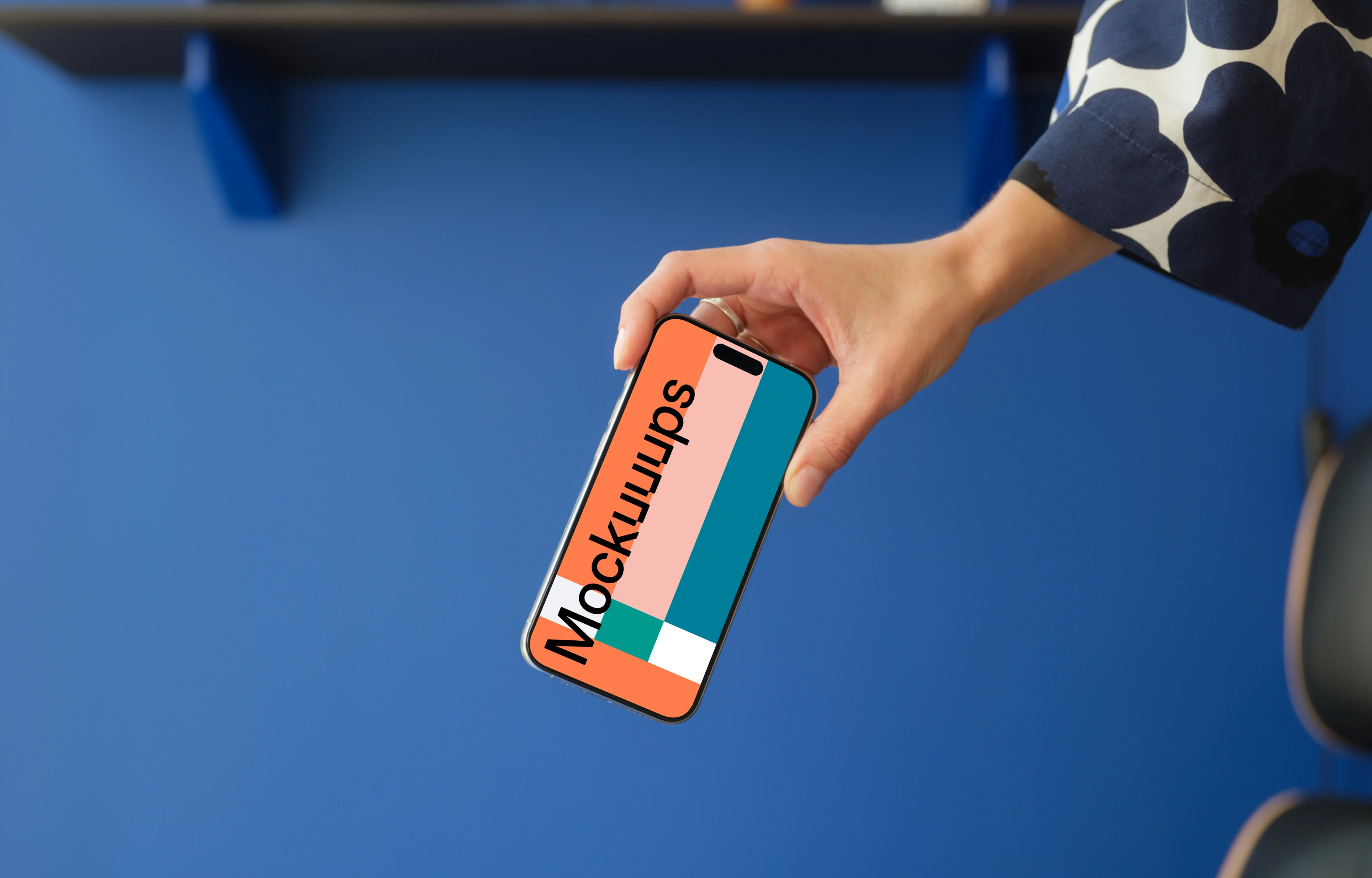 iPhone 15 Pro mockup in a woman's hand against a blue background