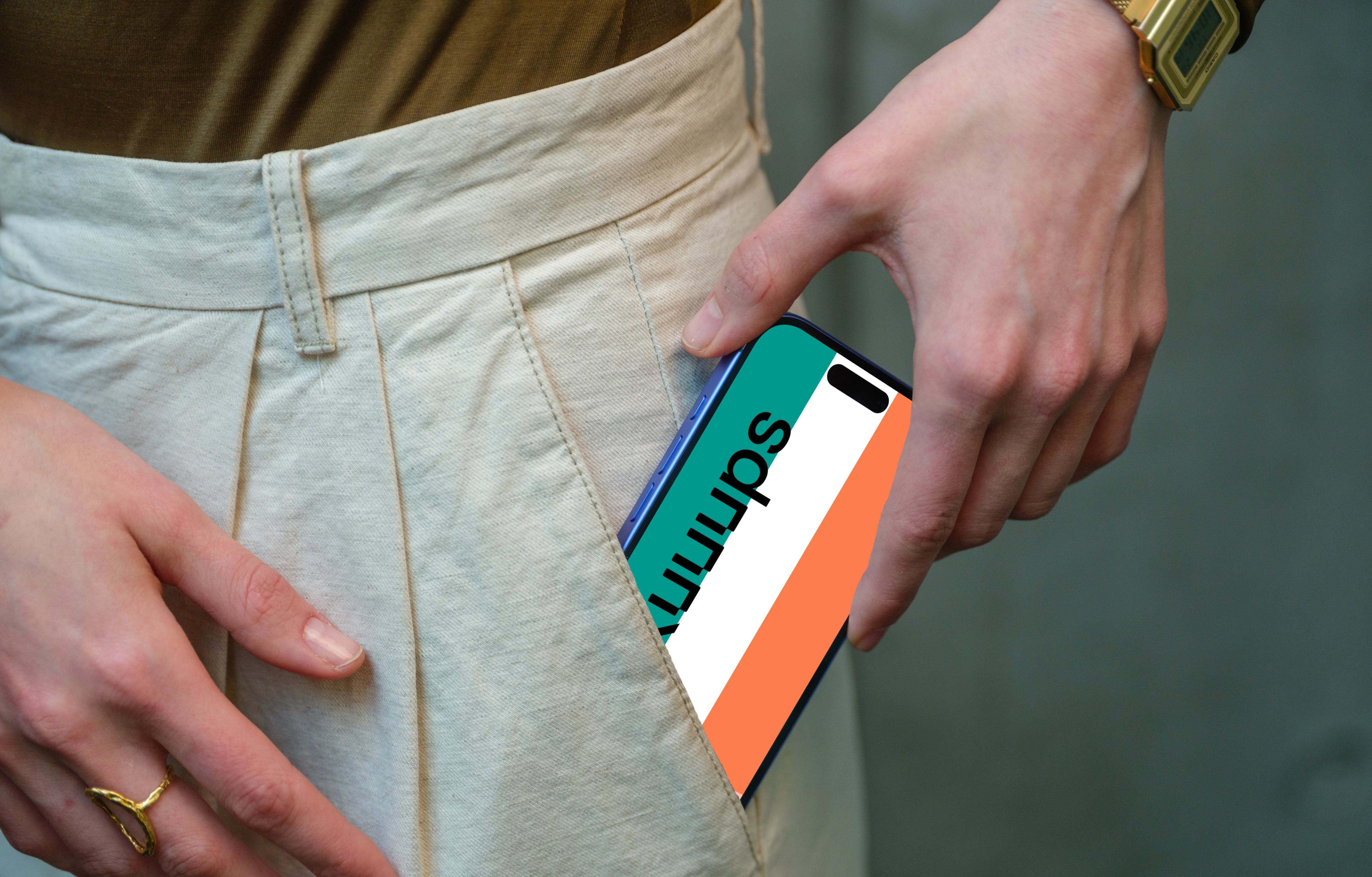 iPhone 16 mockup in hand with casual outfit