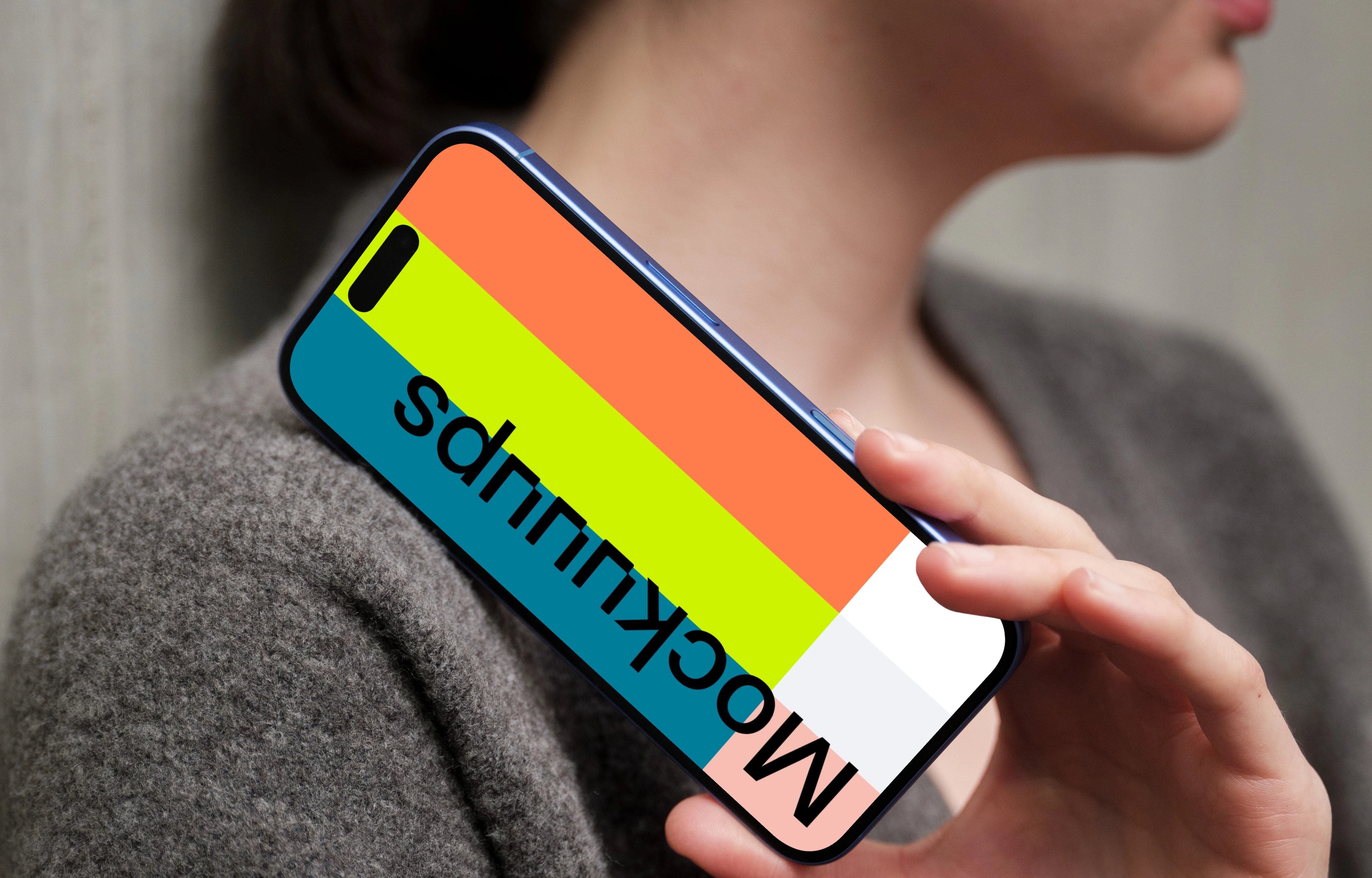 iPhone 16 mockup with hand and concrete wall