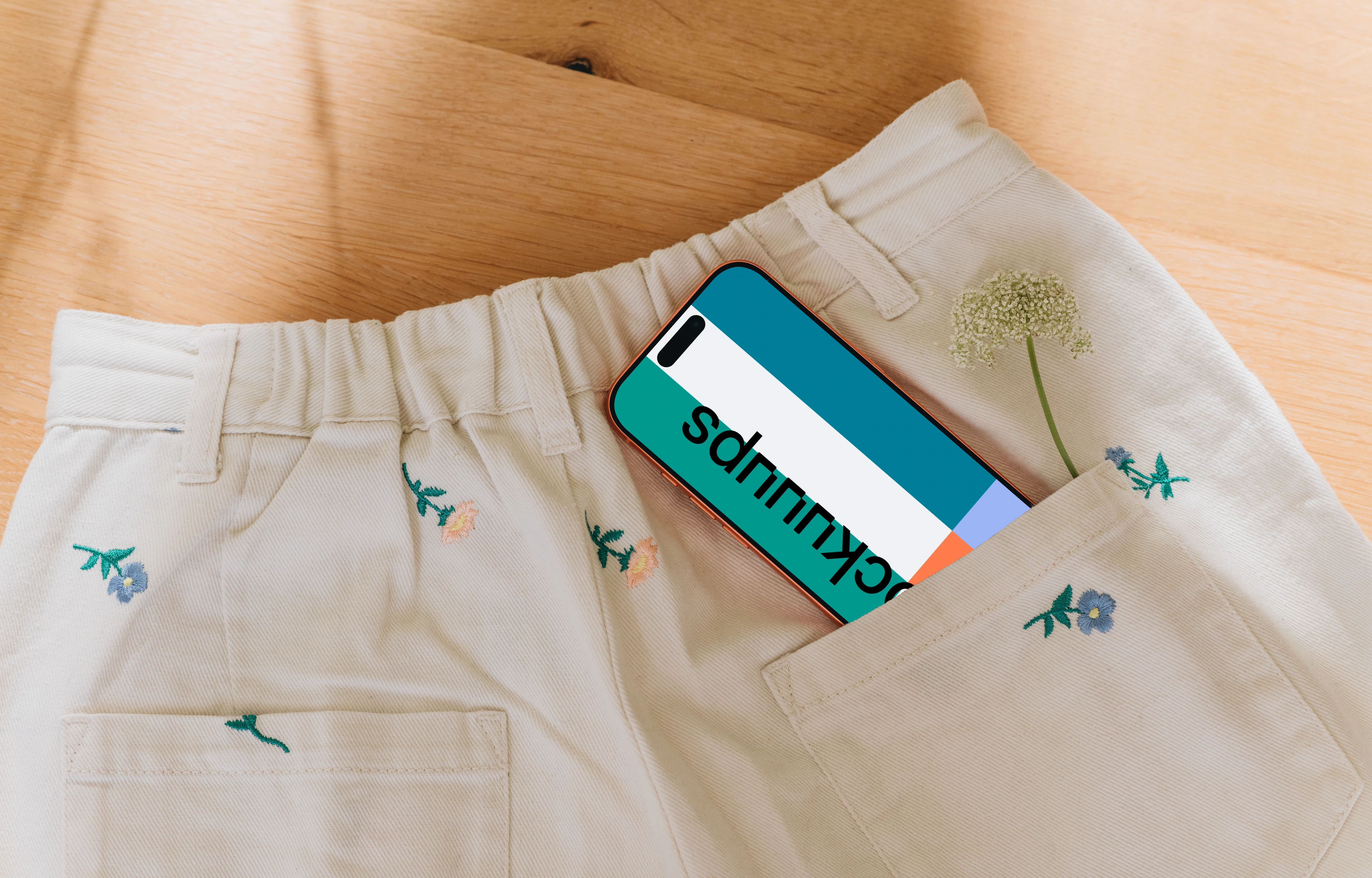 iPhone 17 Pro mockup in a pocket with floral embroidery