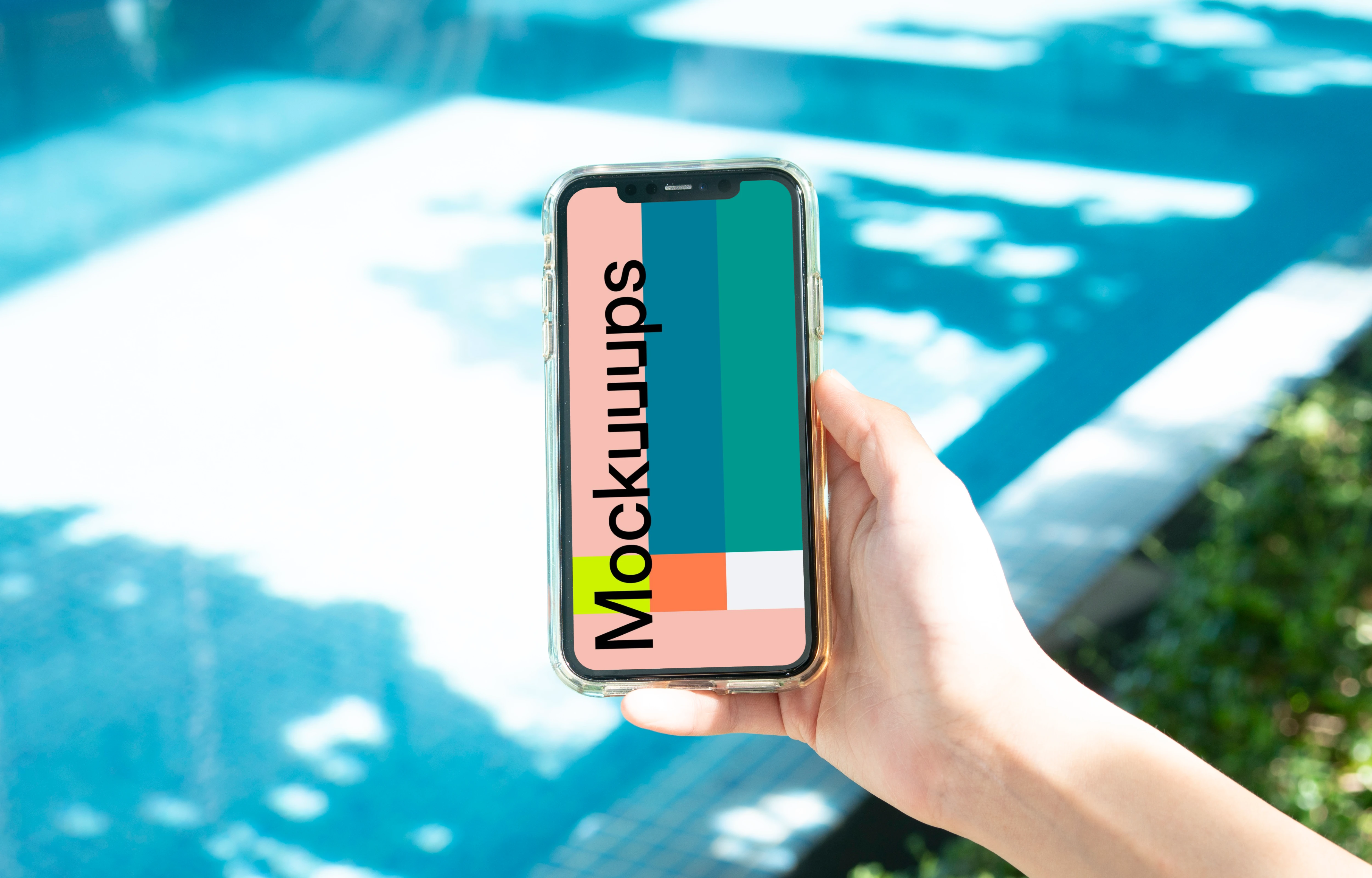 iPhone held beside a swimming pool