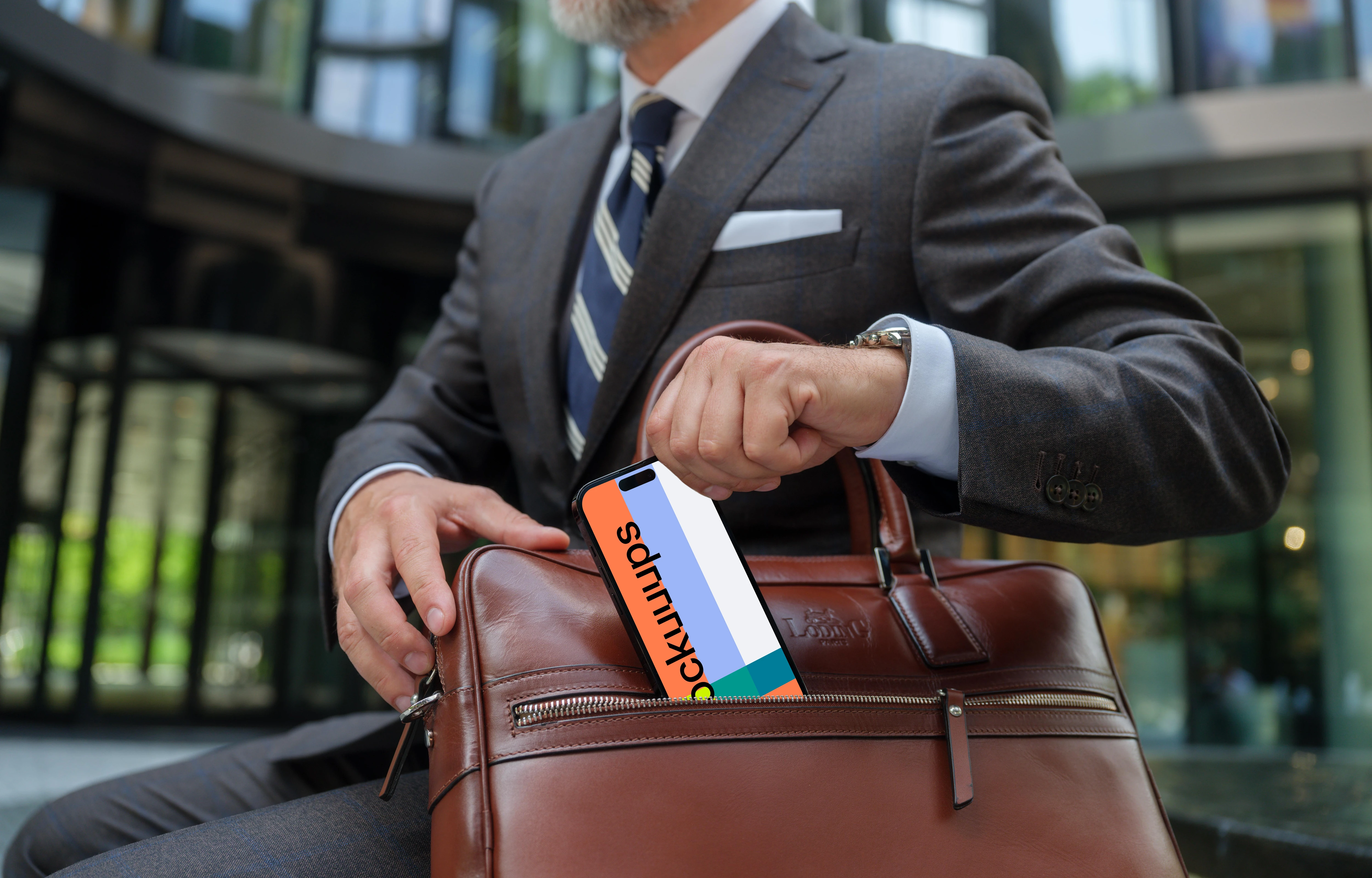 iPhone mockup in businessman’s hand