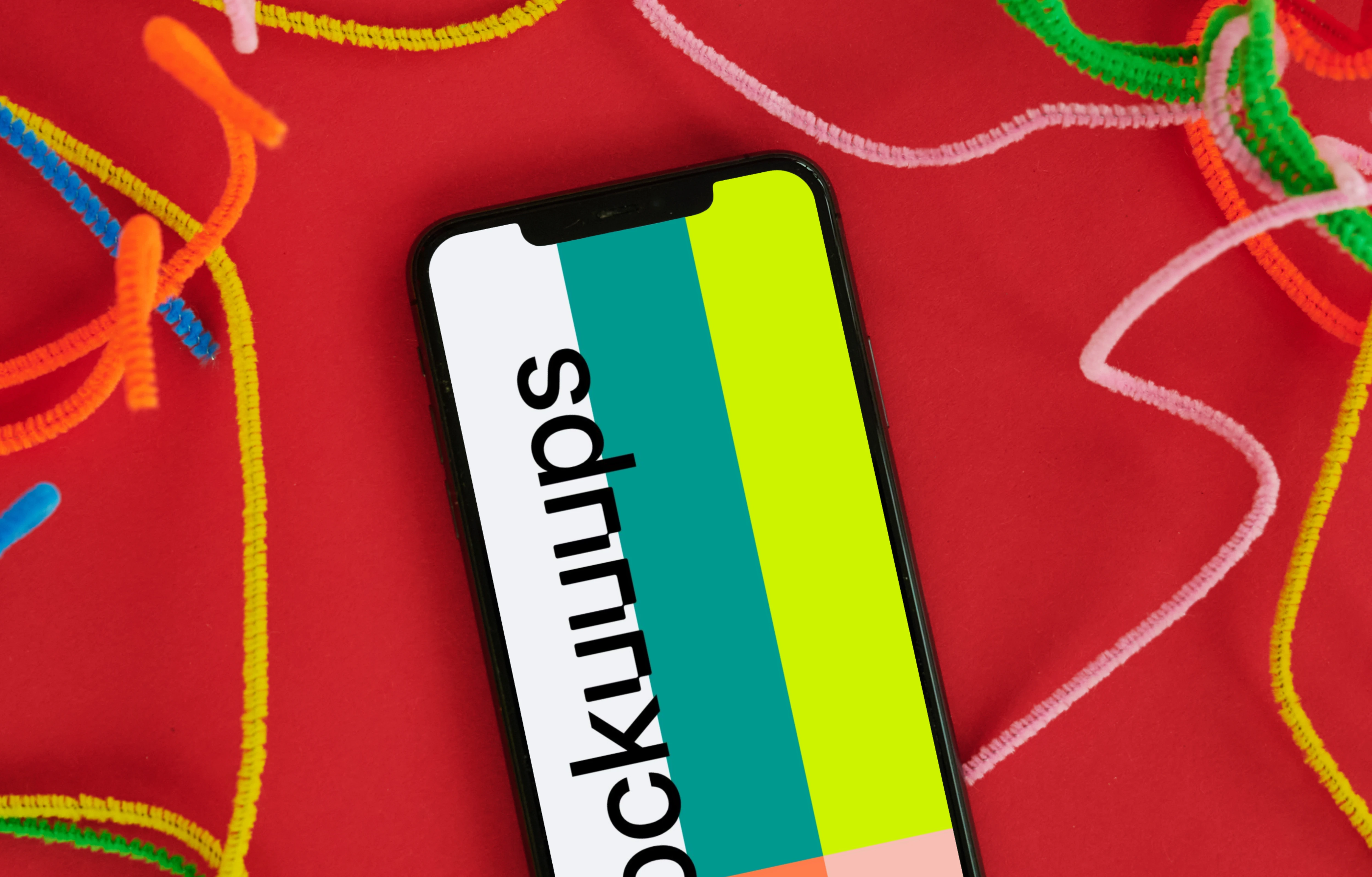 iPhone mockup on a red table