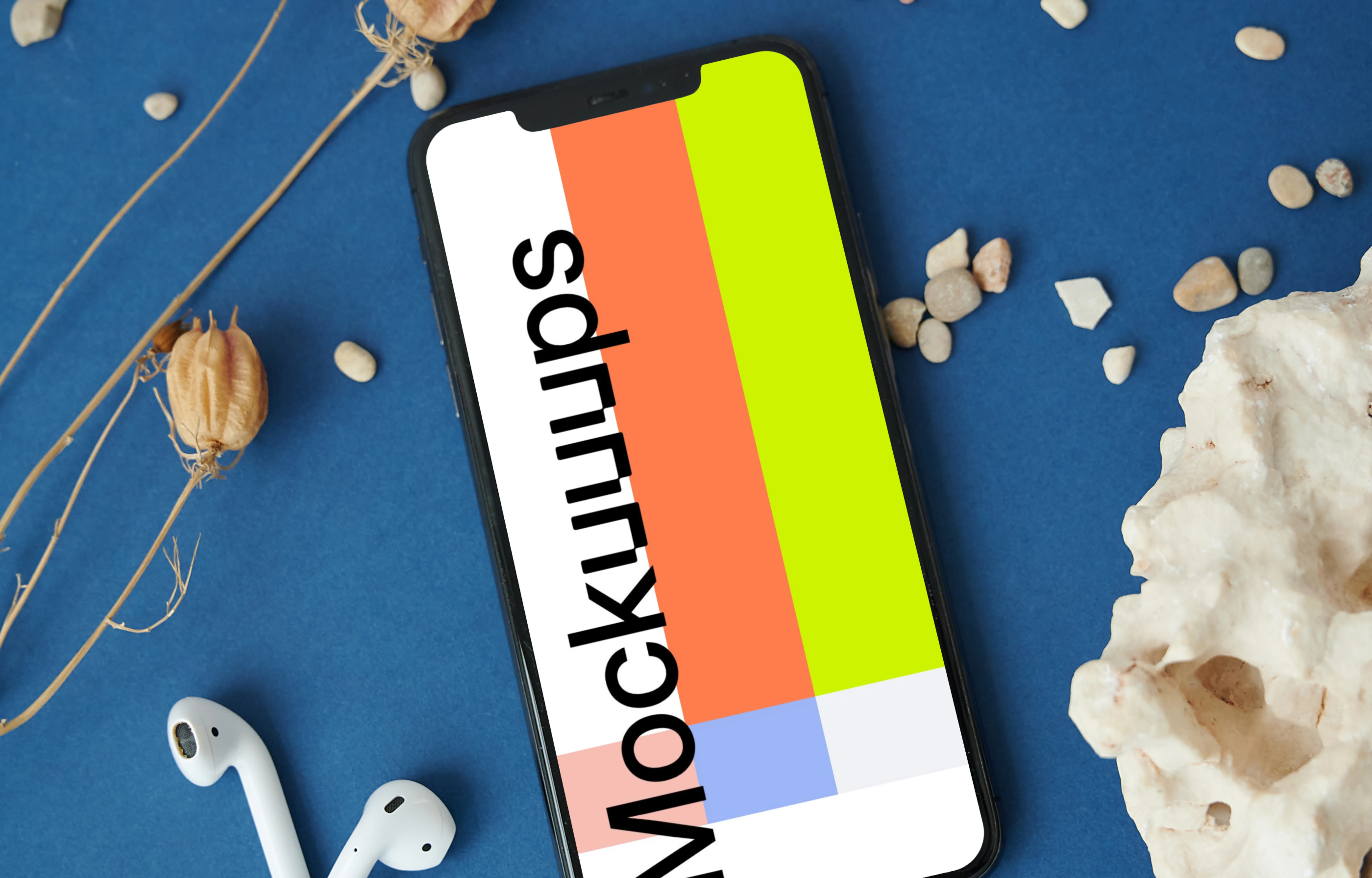 iPhone mockup on a table beside a pair of AirPods