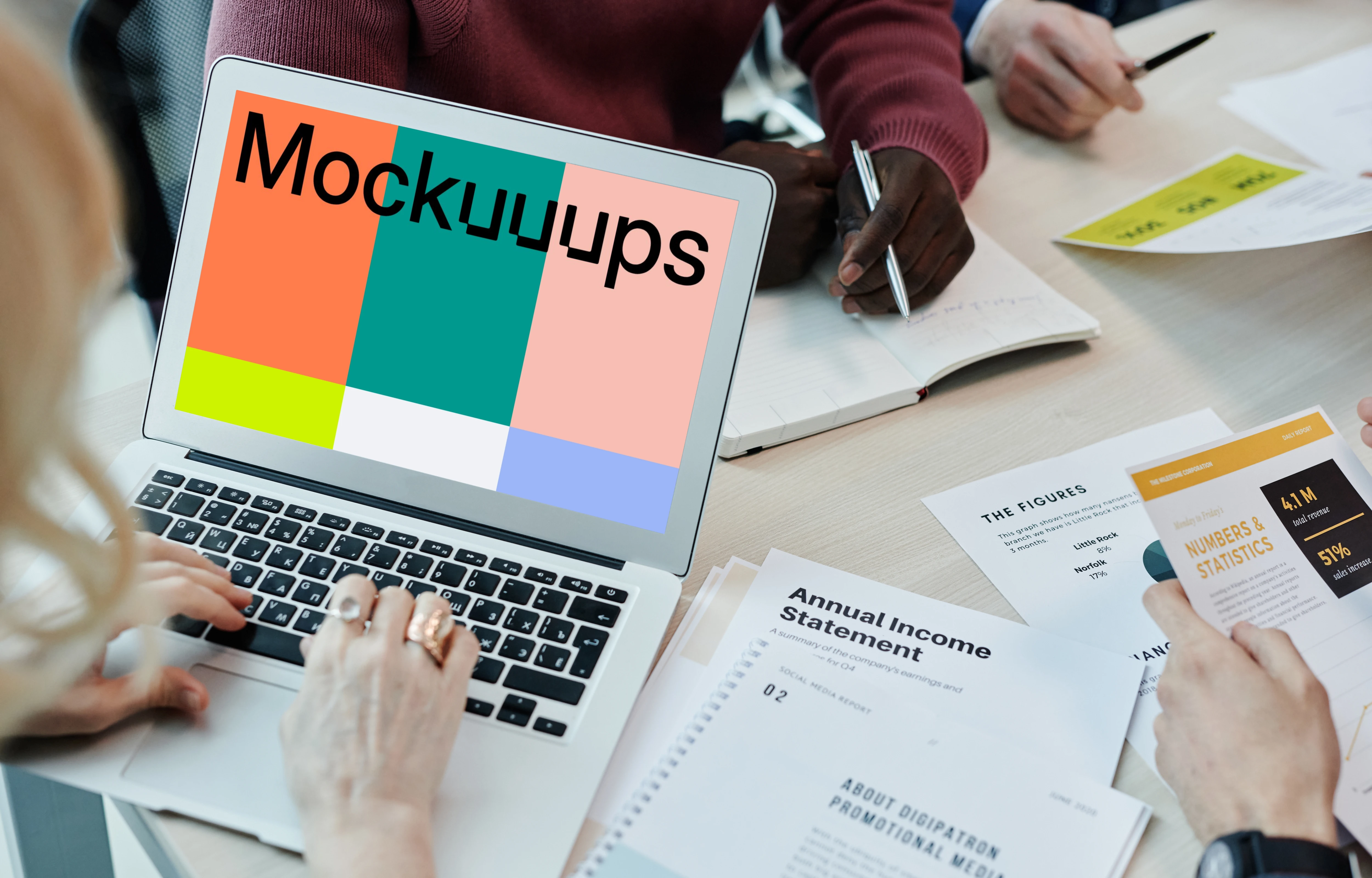 MacBook Air mockup in use at a team meeting