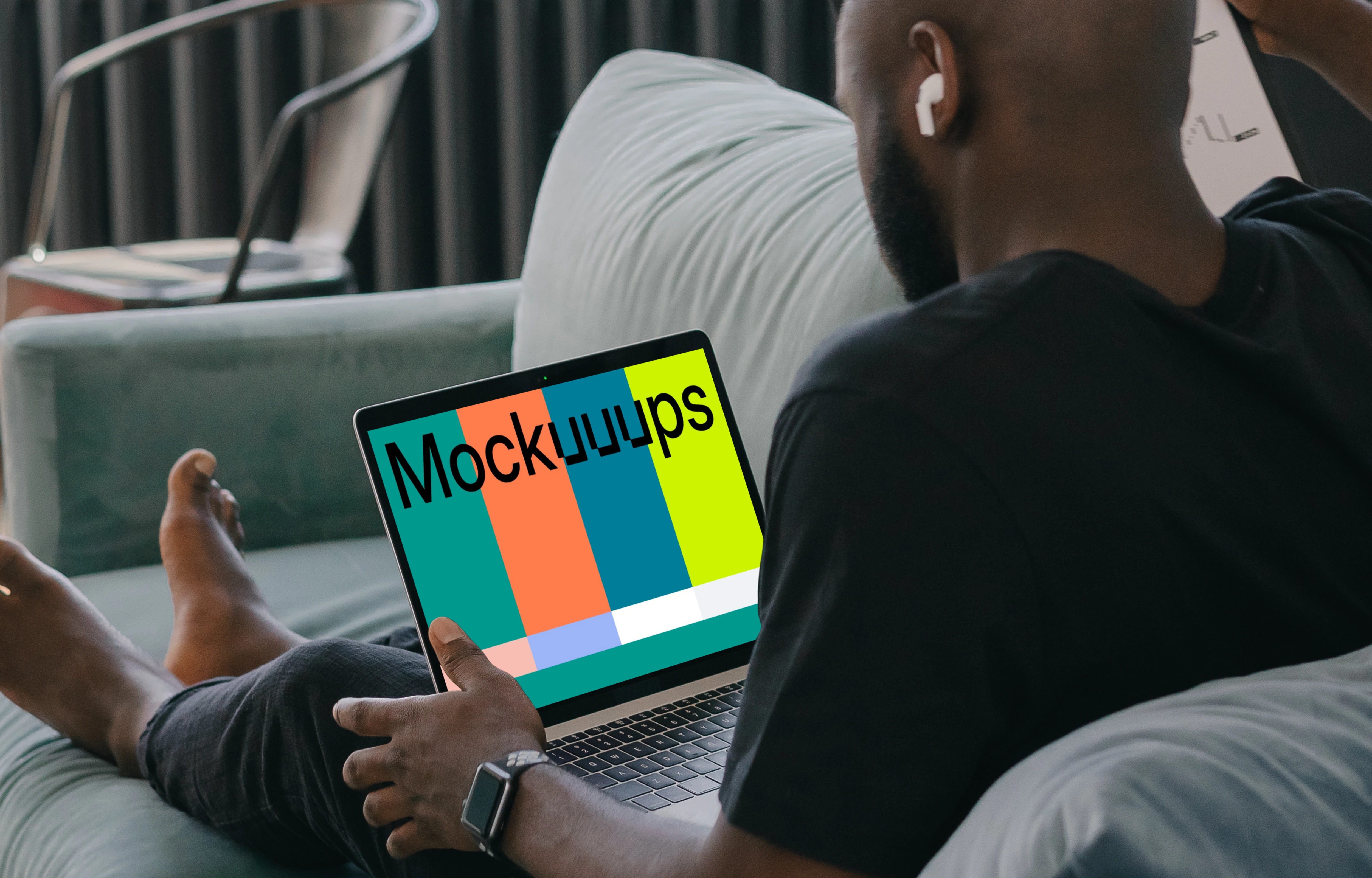MacBook Air mockup in use by a man on a couch