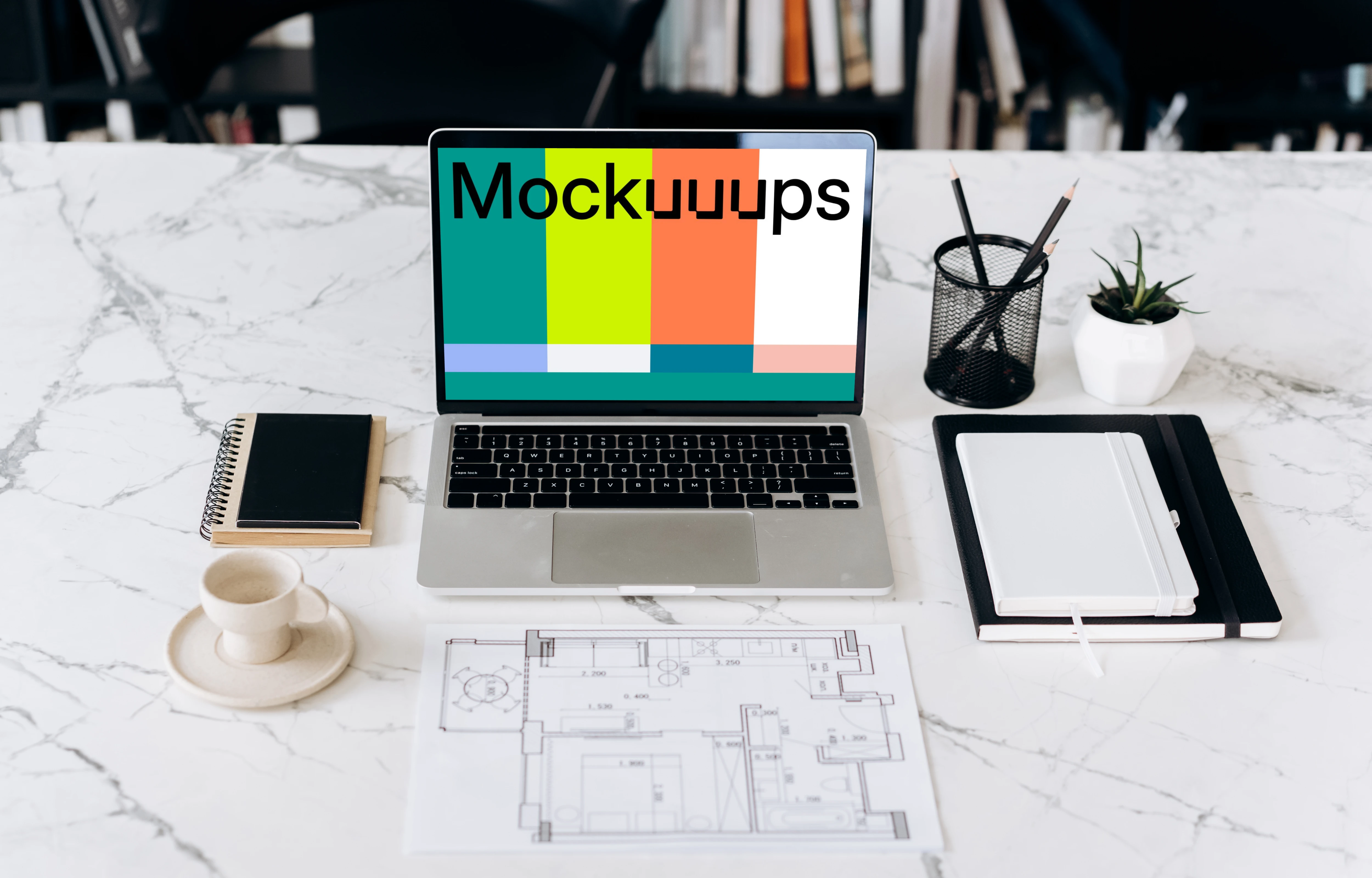 MacBook Pro mockup in front of an architectural plan