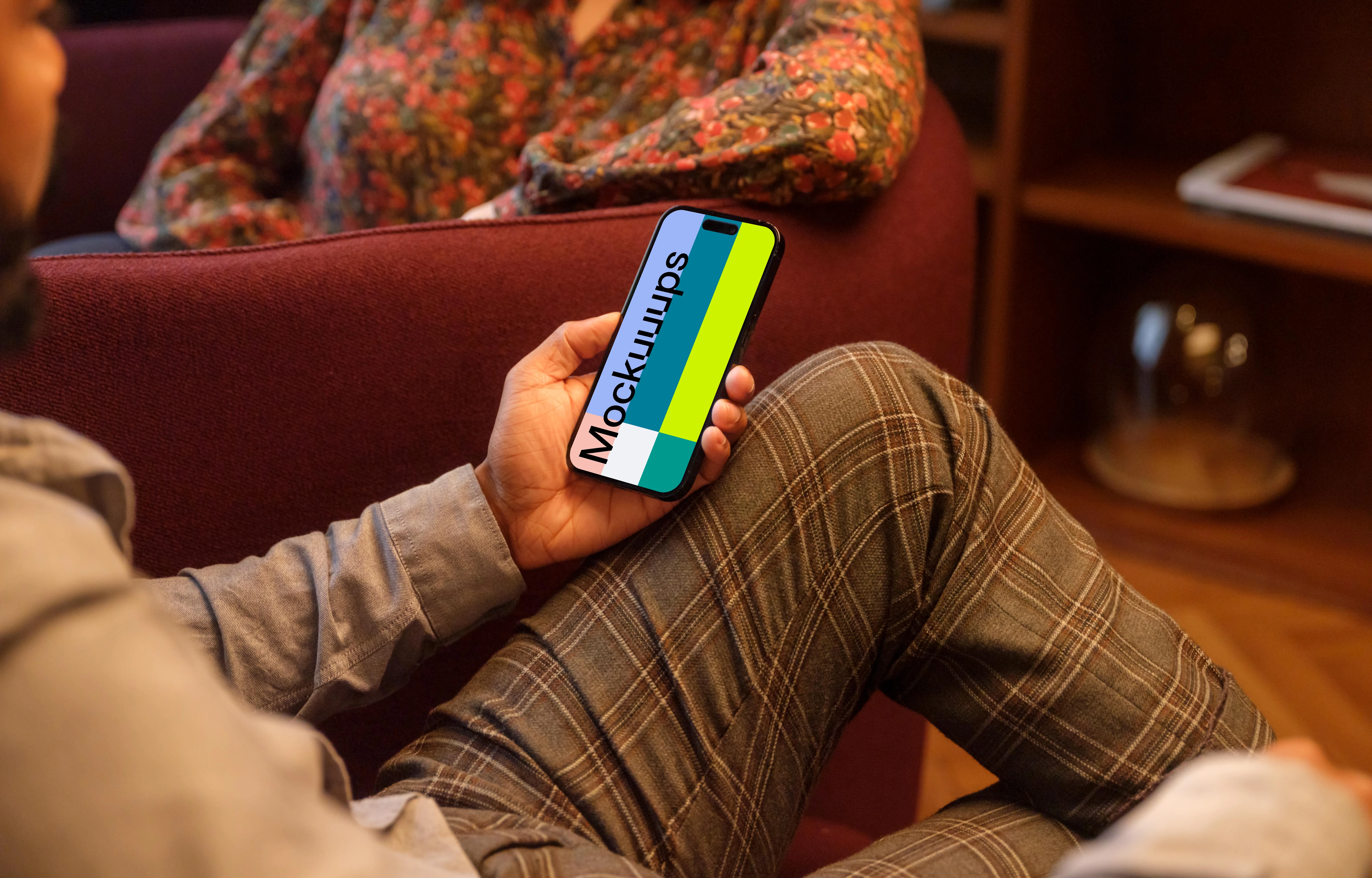 Male hand holding a phone in lounge