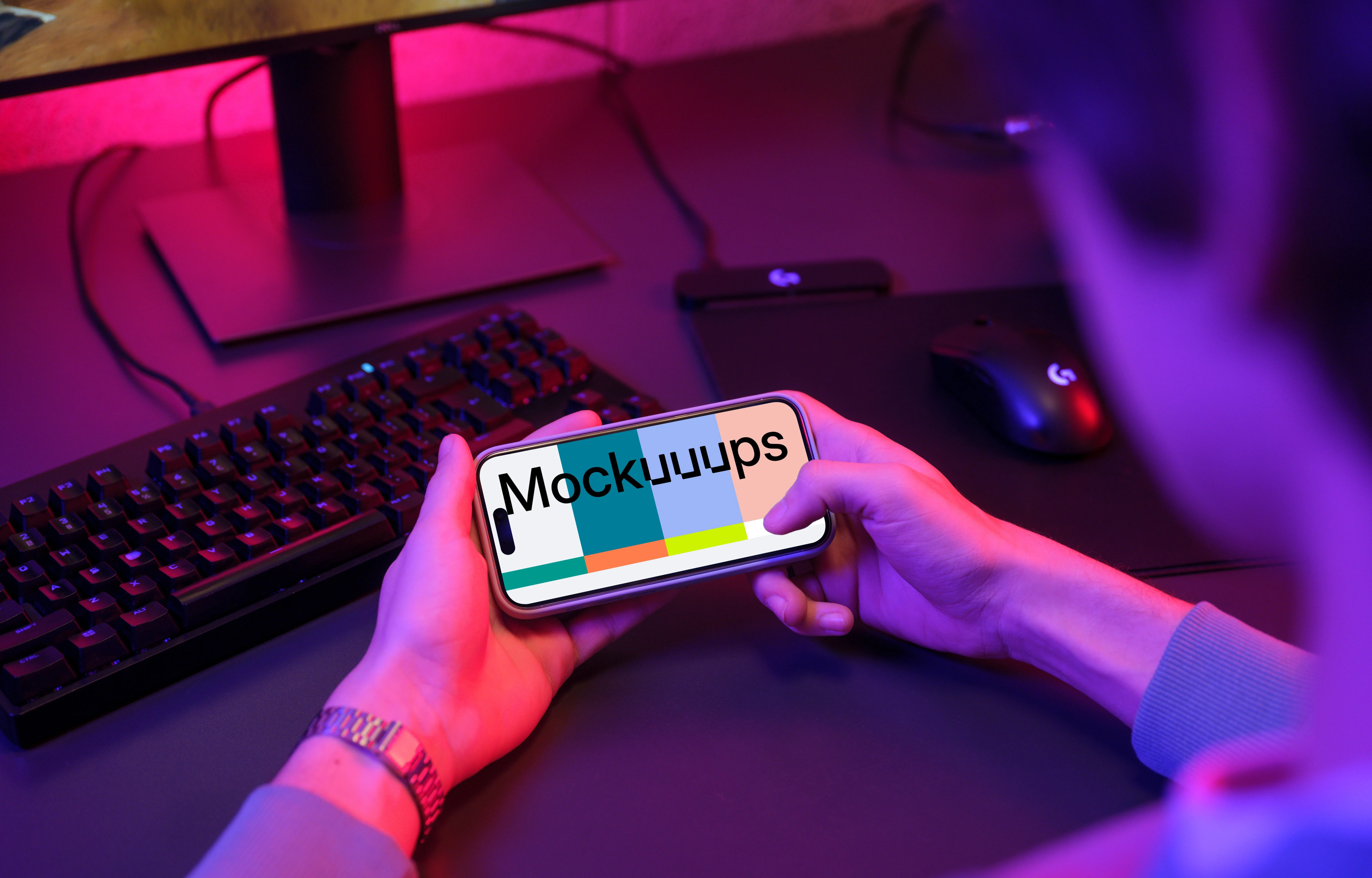 Male hands holding an iPhone mockup in gaming room