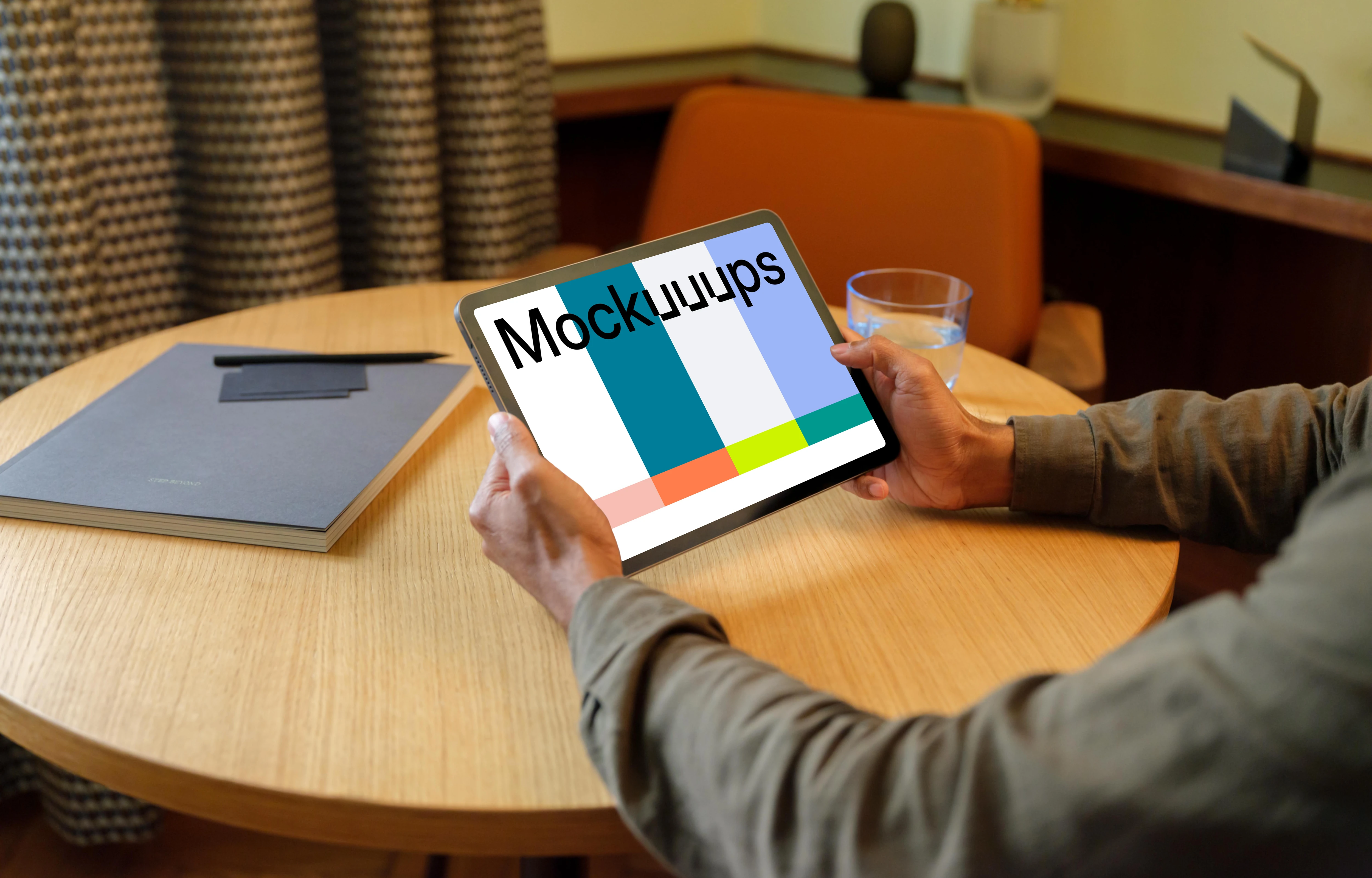 Man holding a iPad mockup in the lounge