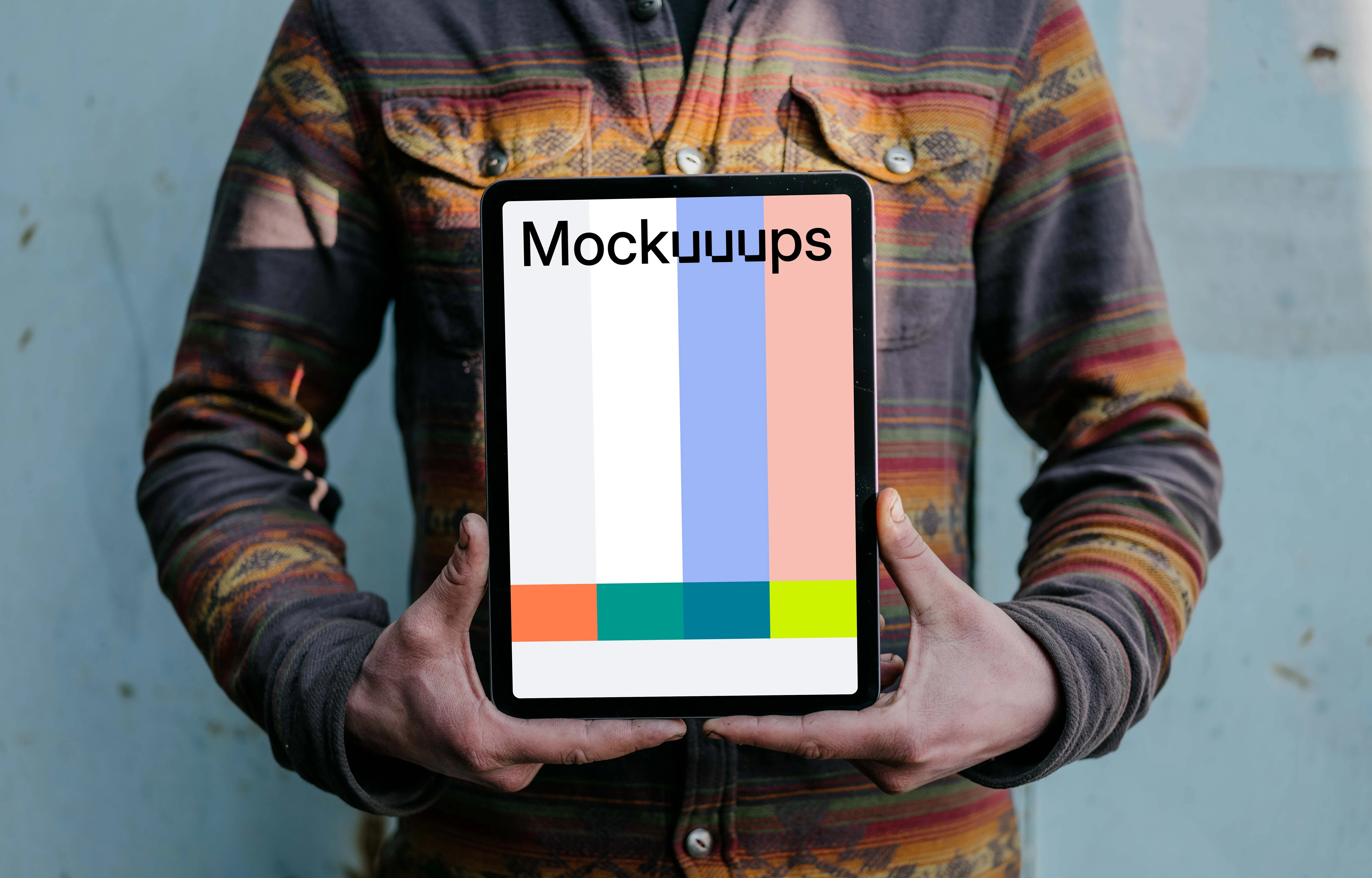 Man holding an iPad Air mockup in potrait mode