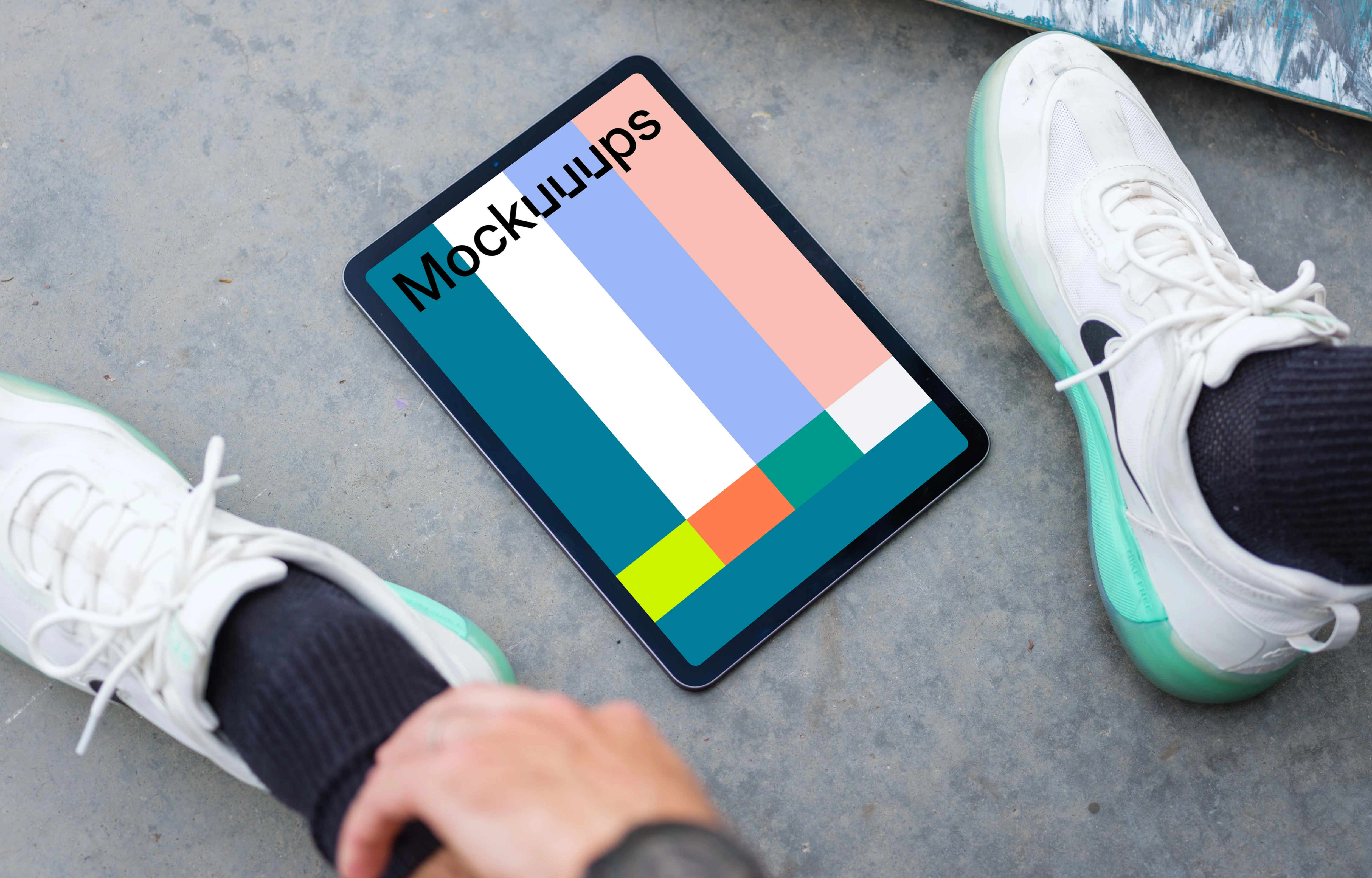 Man sitting next to an iPad Air mockup