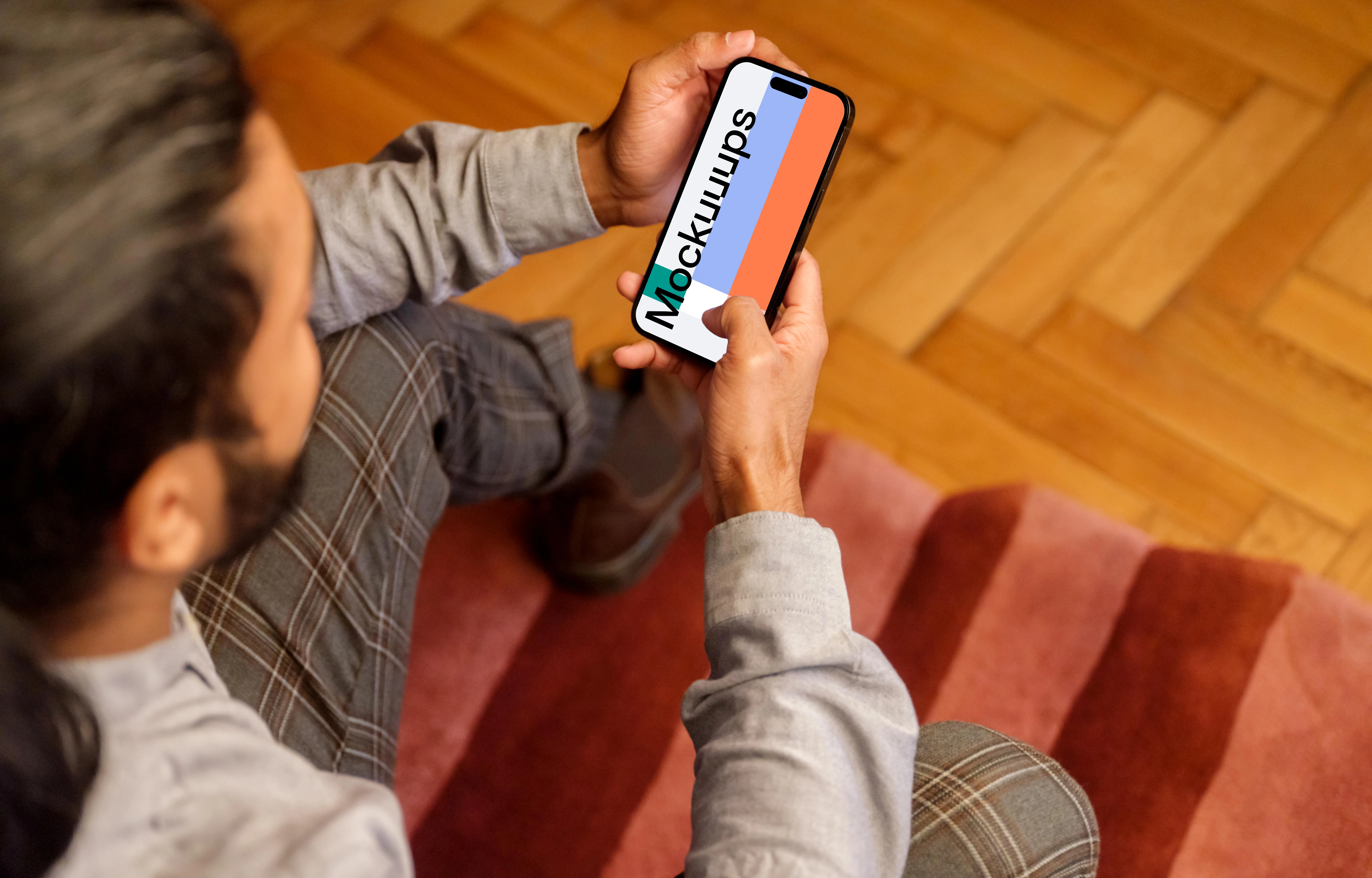 Man typing on a iPhone 14 Pro mockup in the office