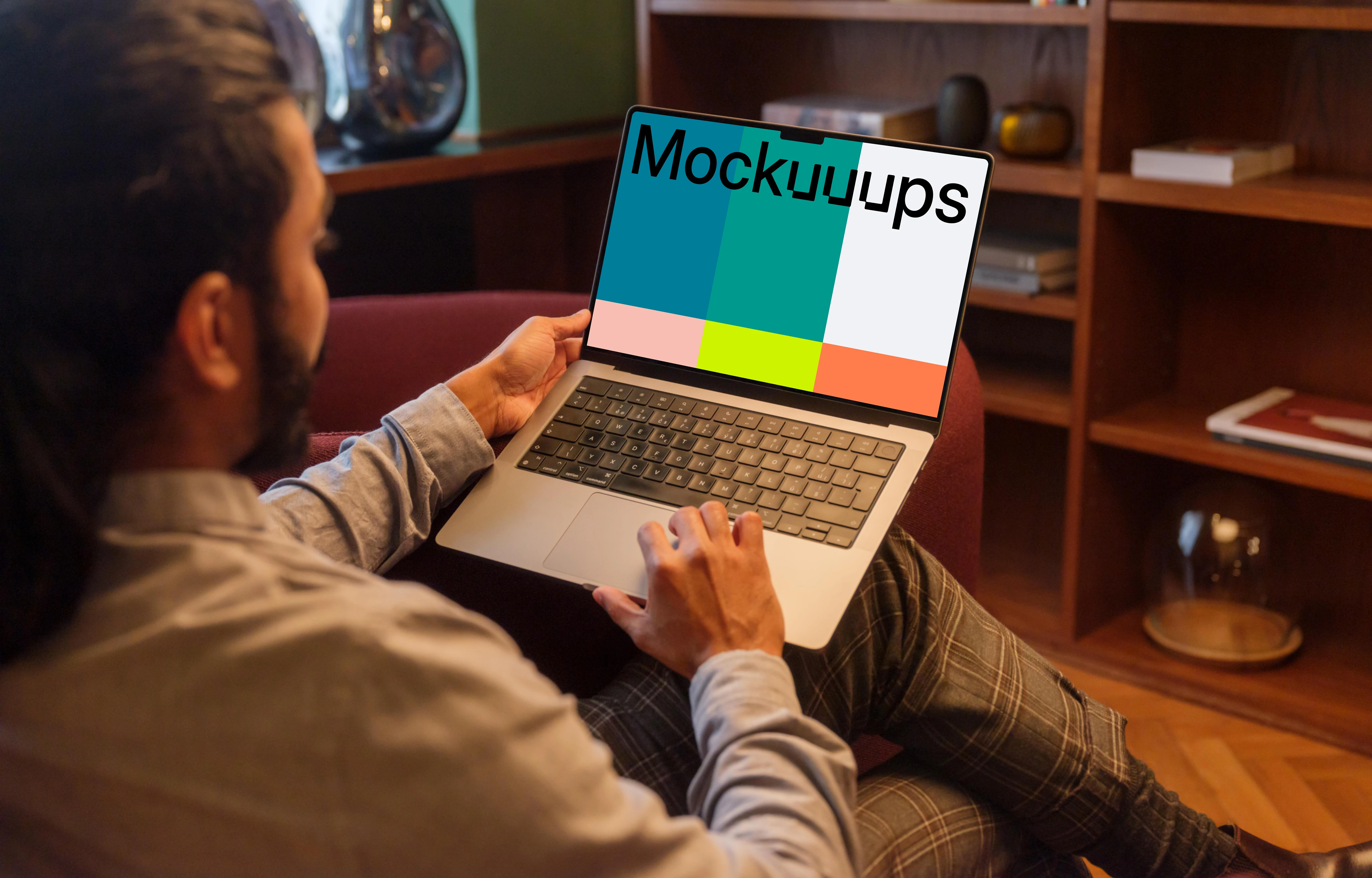 Man working on a MacBook Pro in office