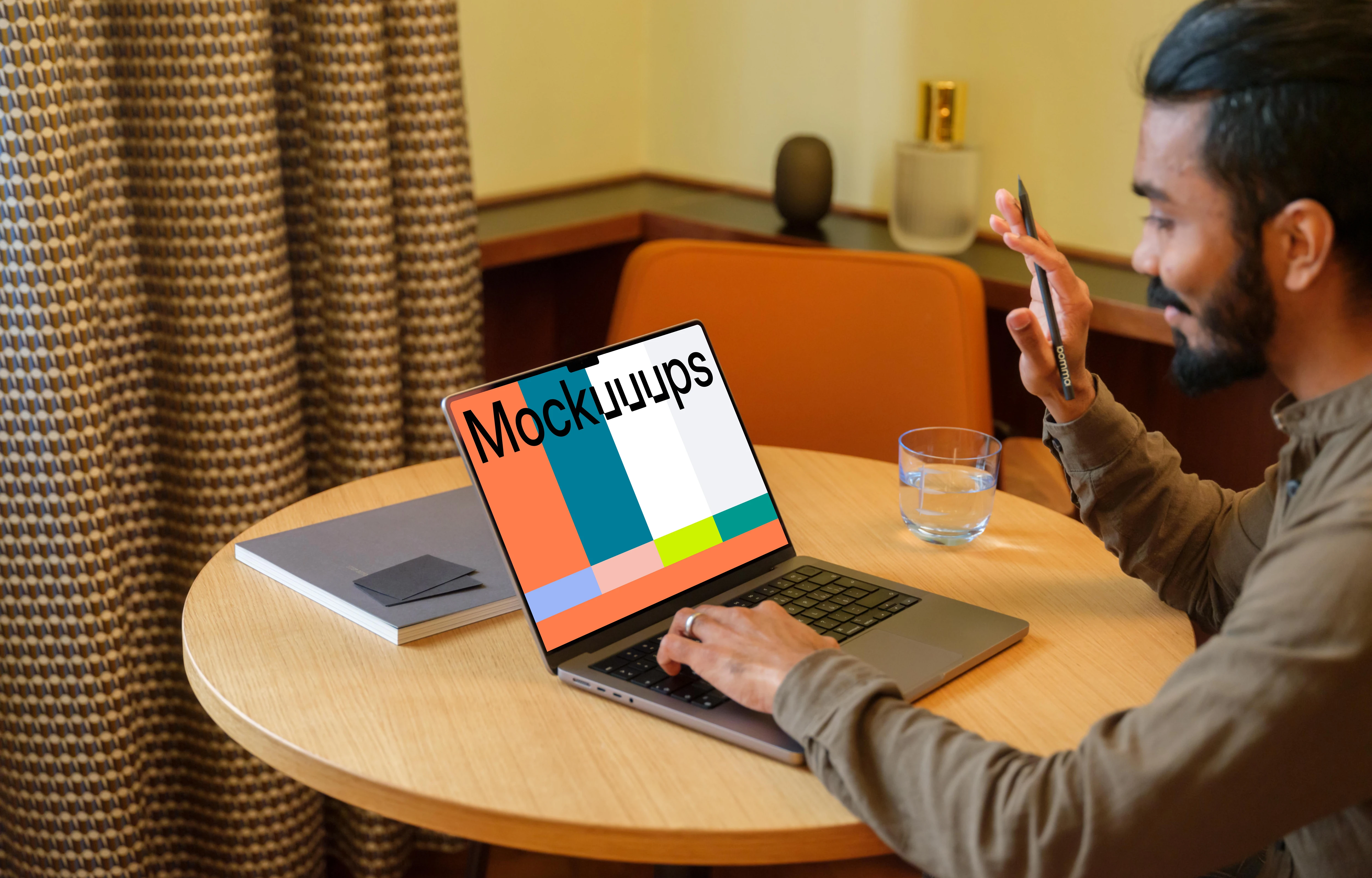 Man working on a MacBook Pro mockup in lounge 