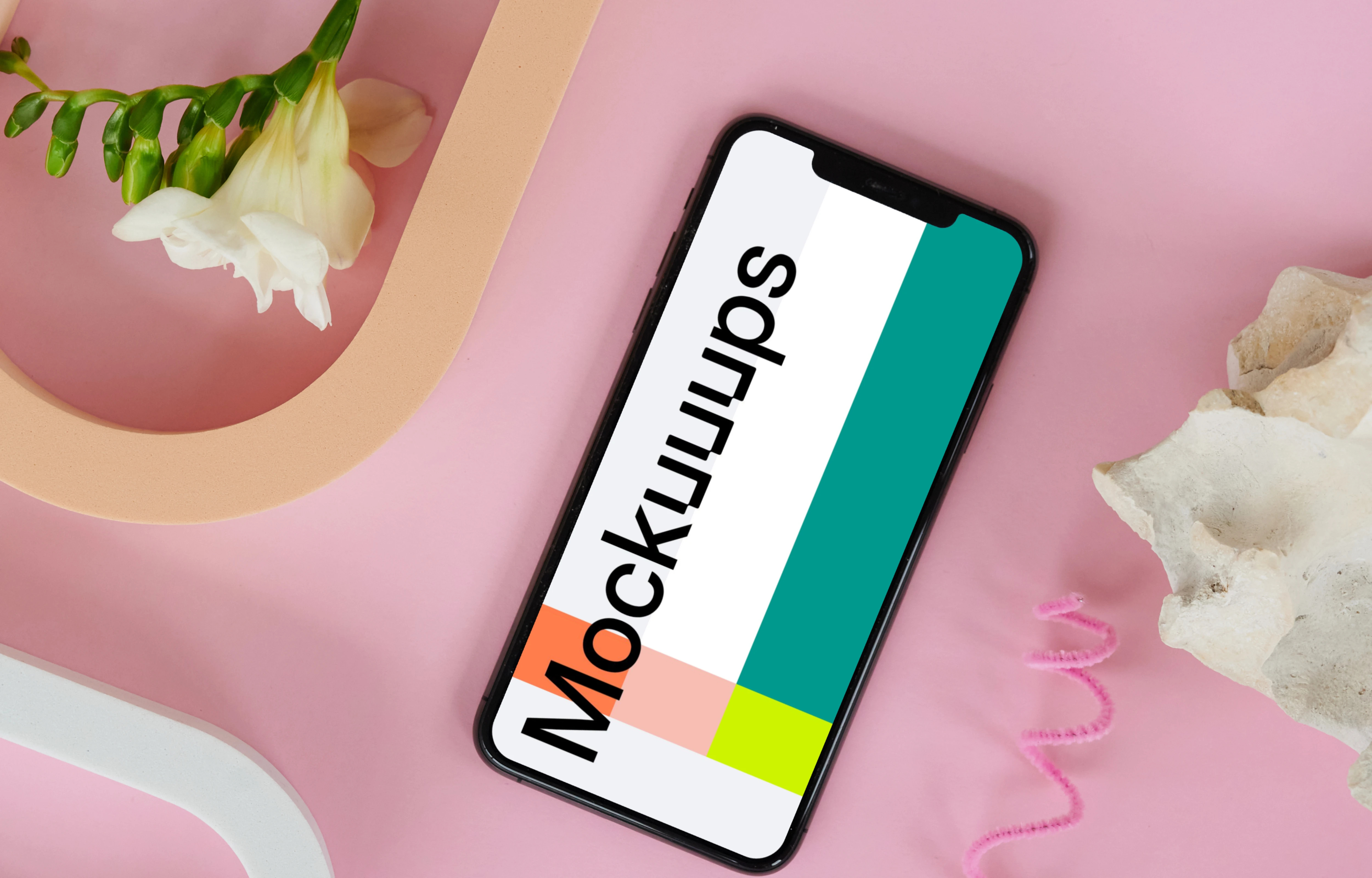 iPhone 12 mockup on a pink table