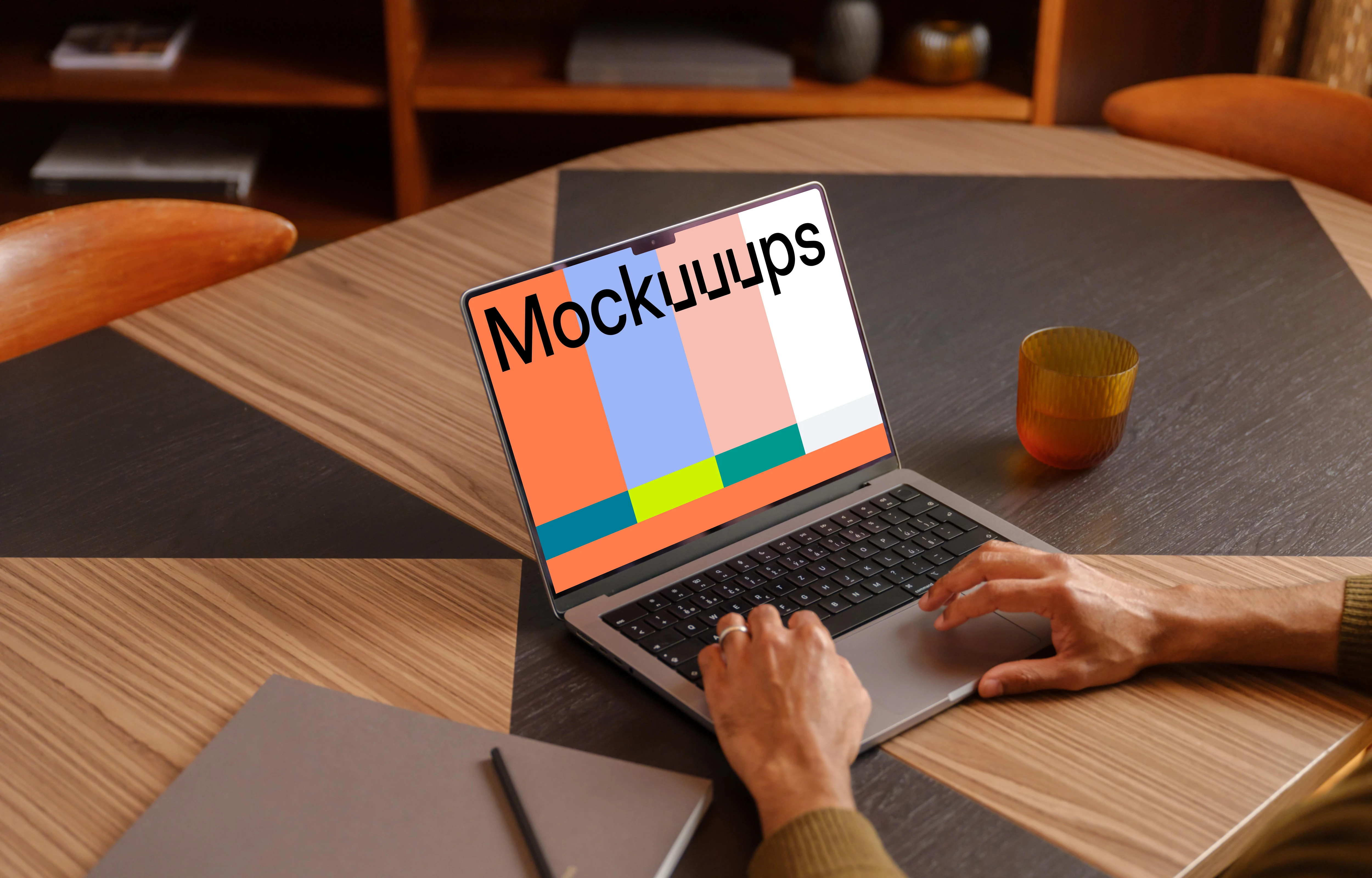 Office environment and man typing on a laptop mockup