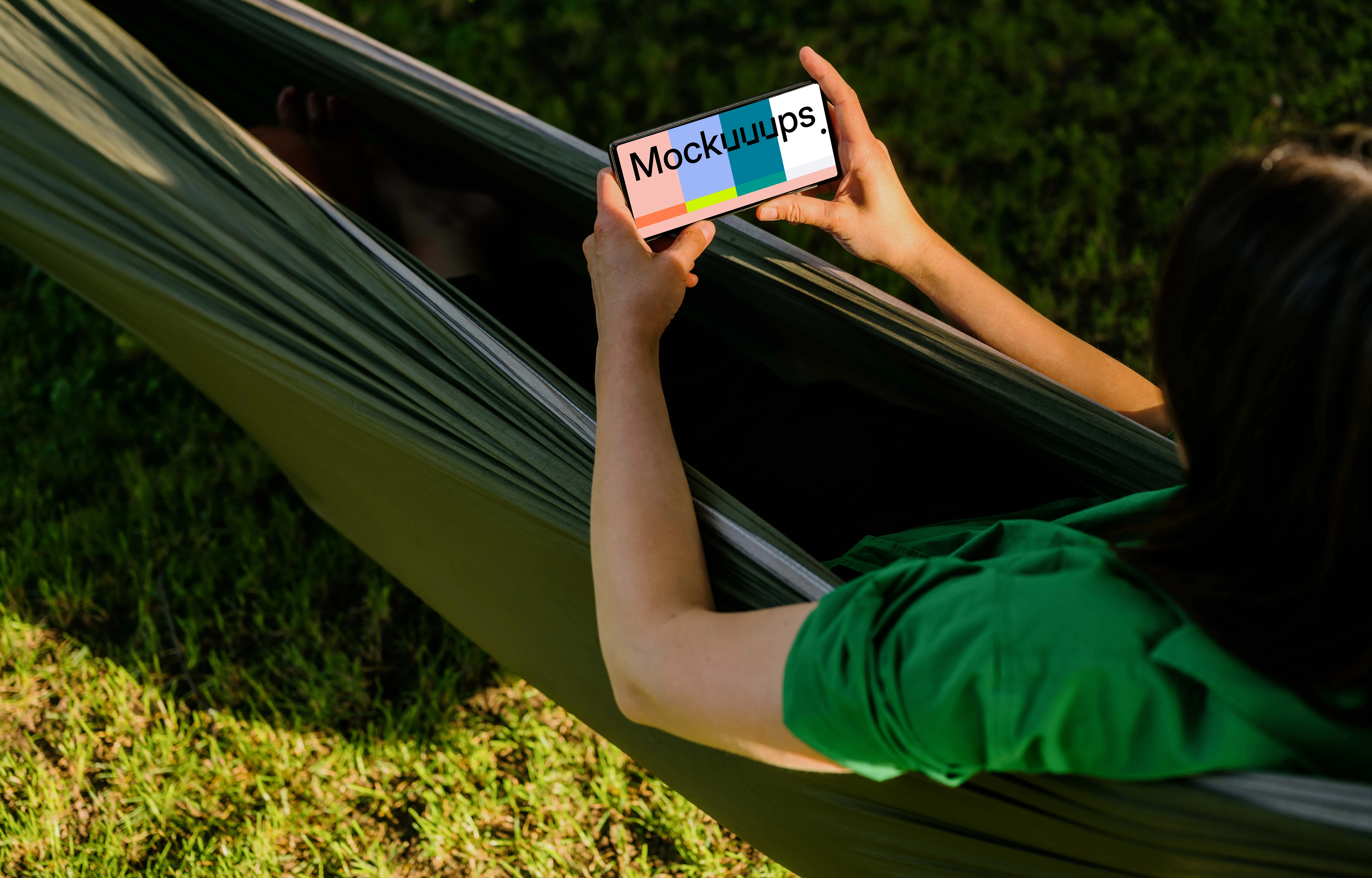 Female laying in a hammock while holding a Google Pixel 6 mockup