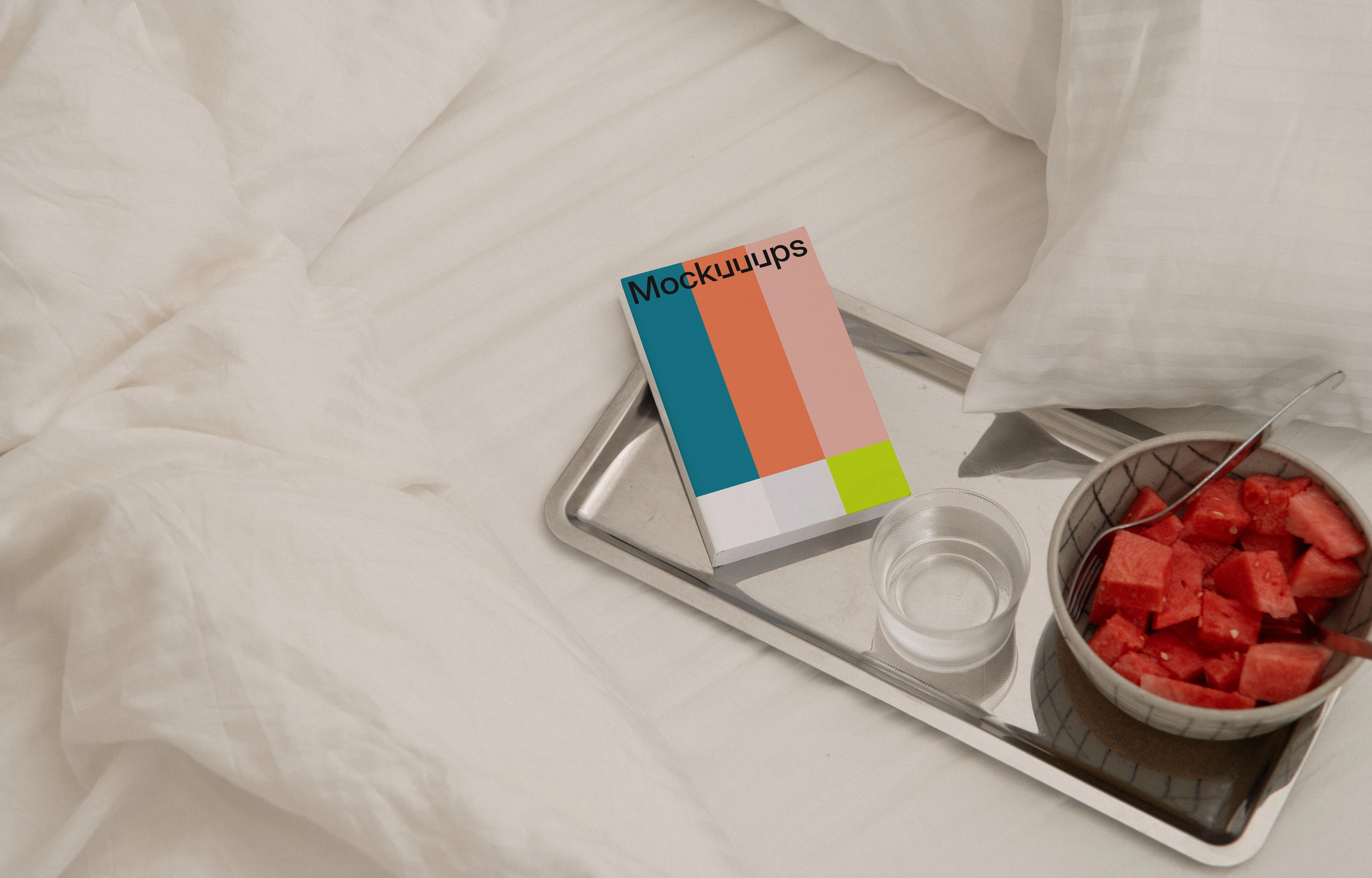 Paperback book mockup on a breakfast tray in a cozy bed