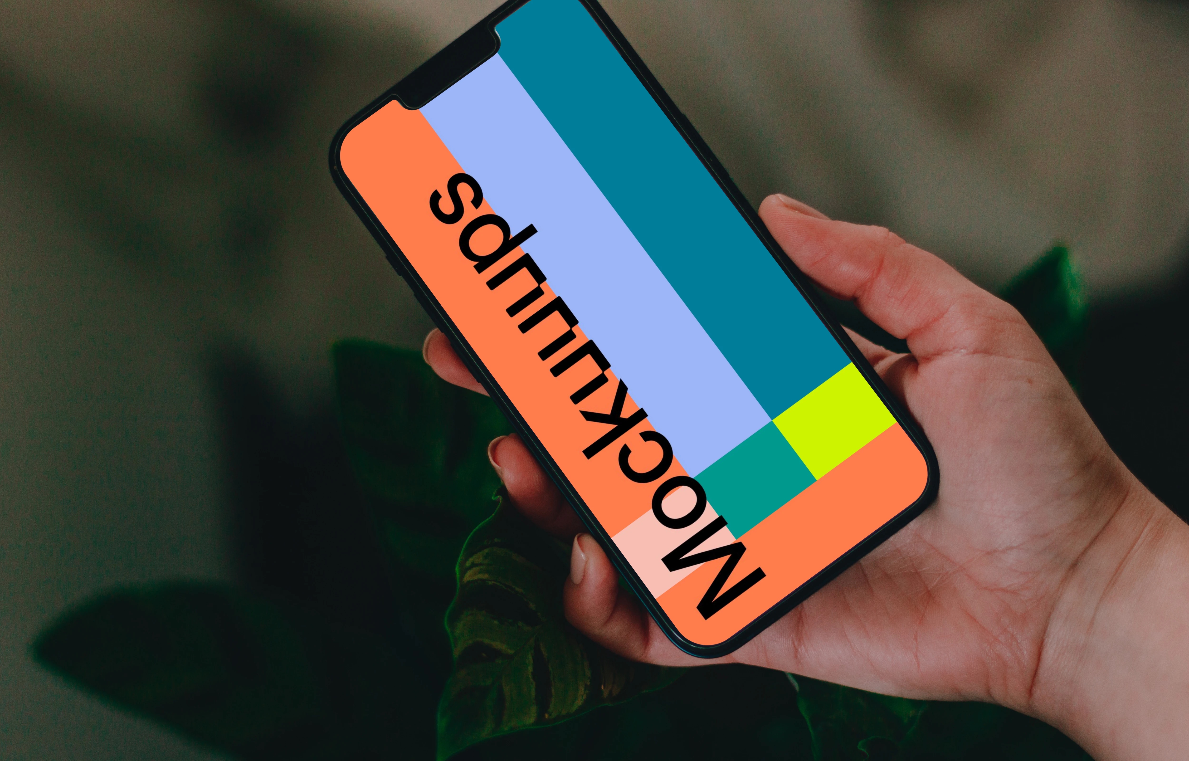 Person holding up an iPhone 13 Pro mockup