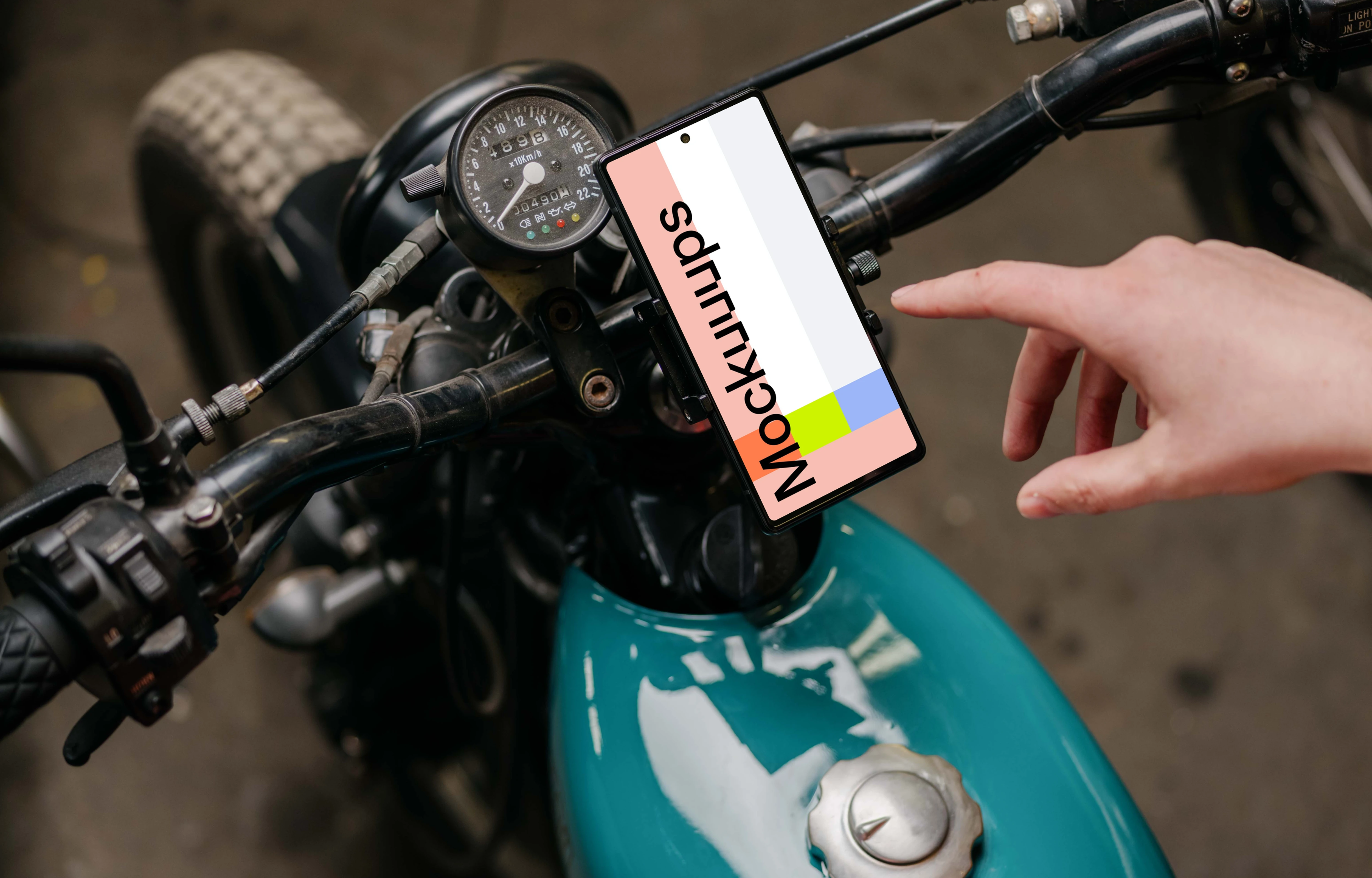 Person using a Pixel 6 mockup on a motorcycle