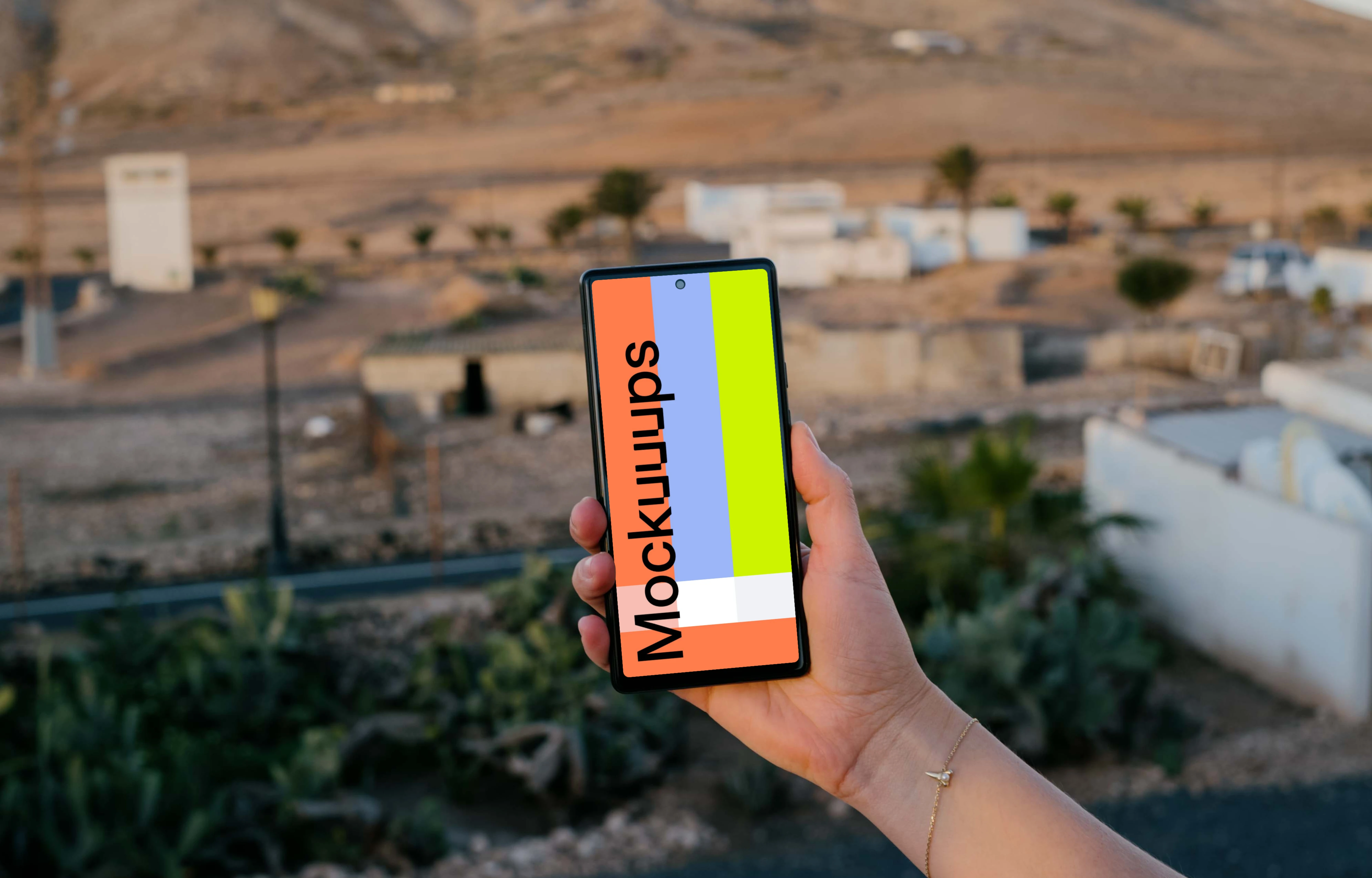 Smartphone mockup held by user over an open field