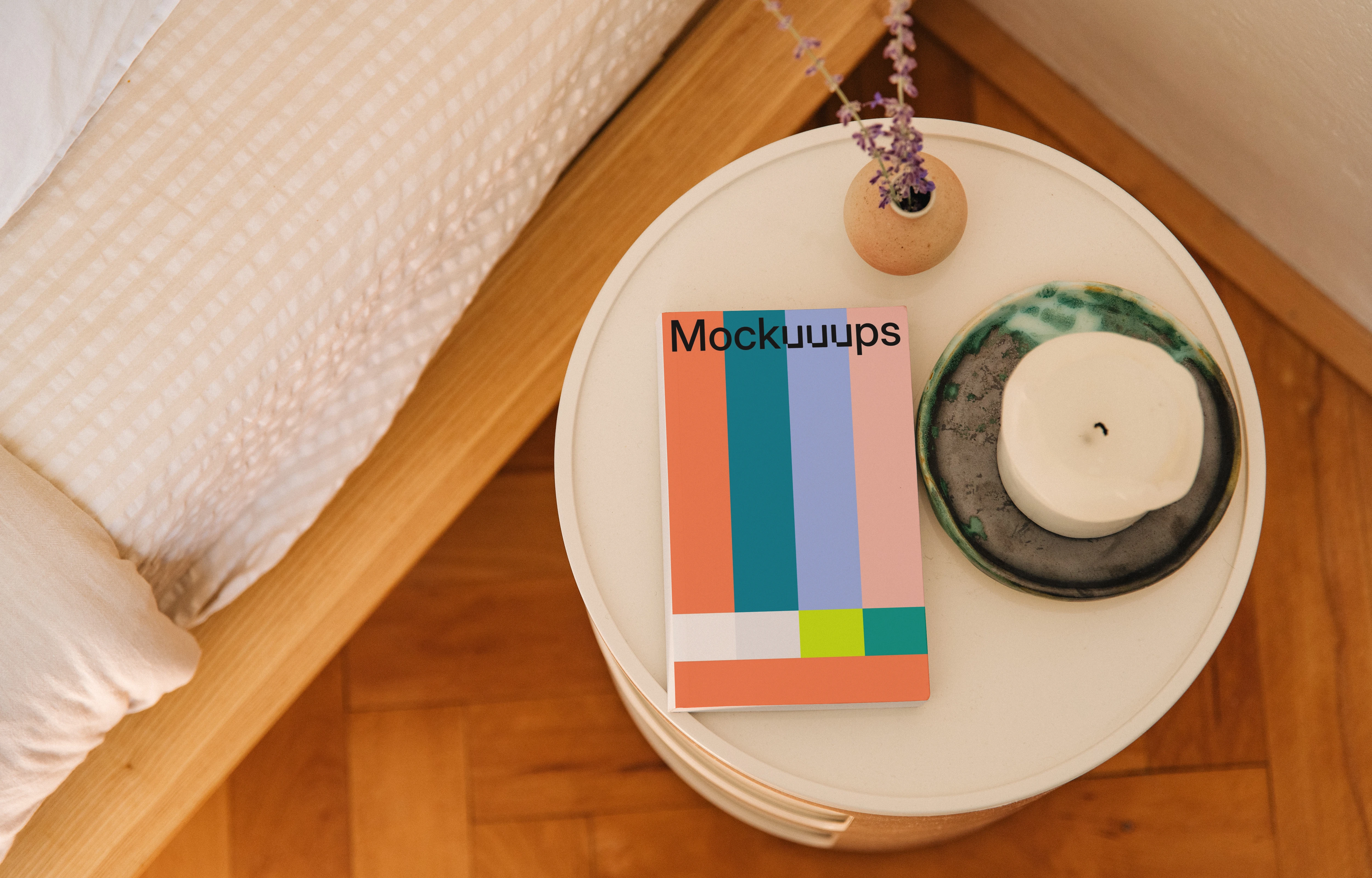 Softcover book mockup on a bedside table