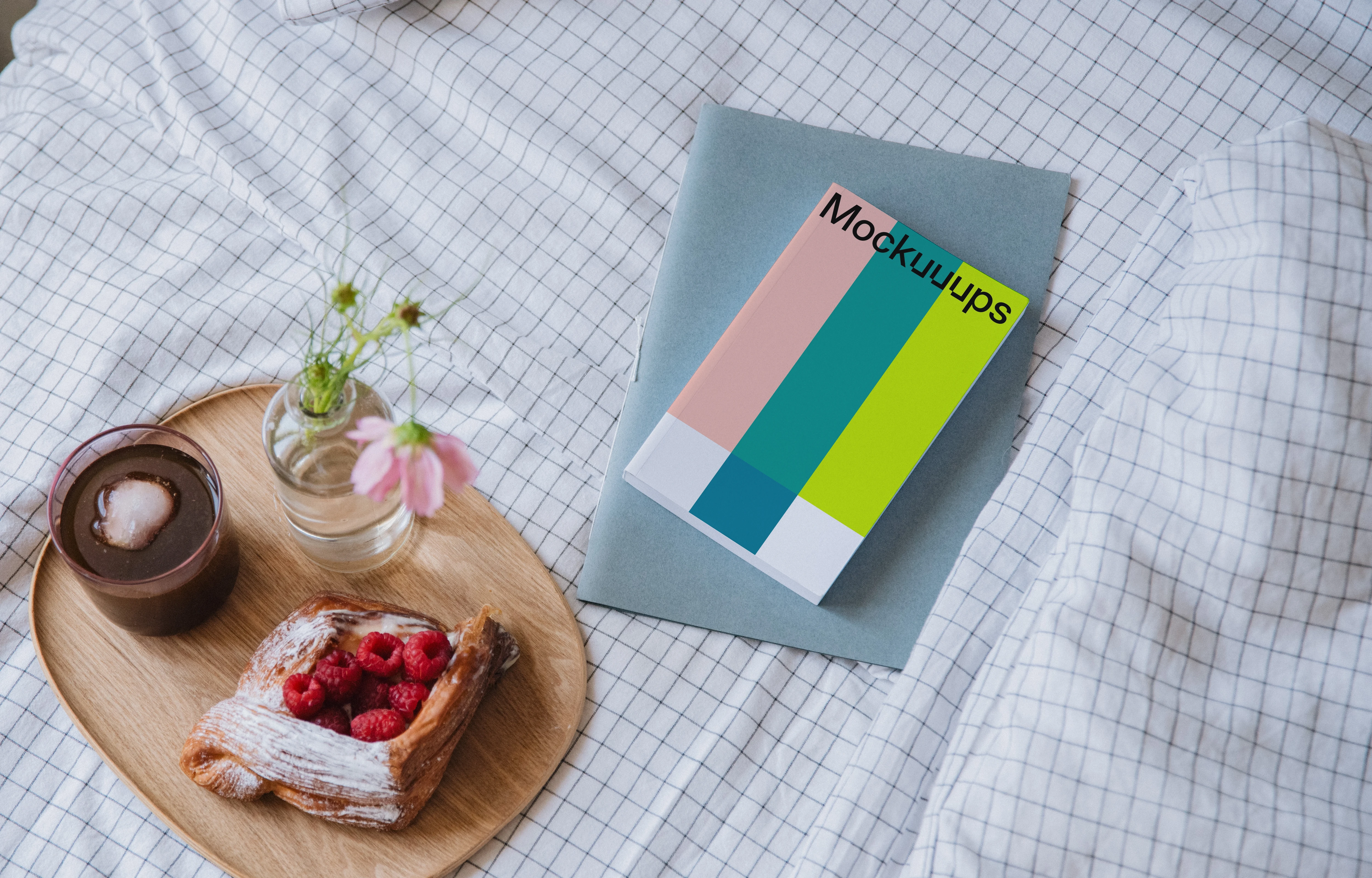 Softcover book mockup on a cozy bed with breakfast tray