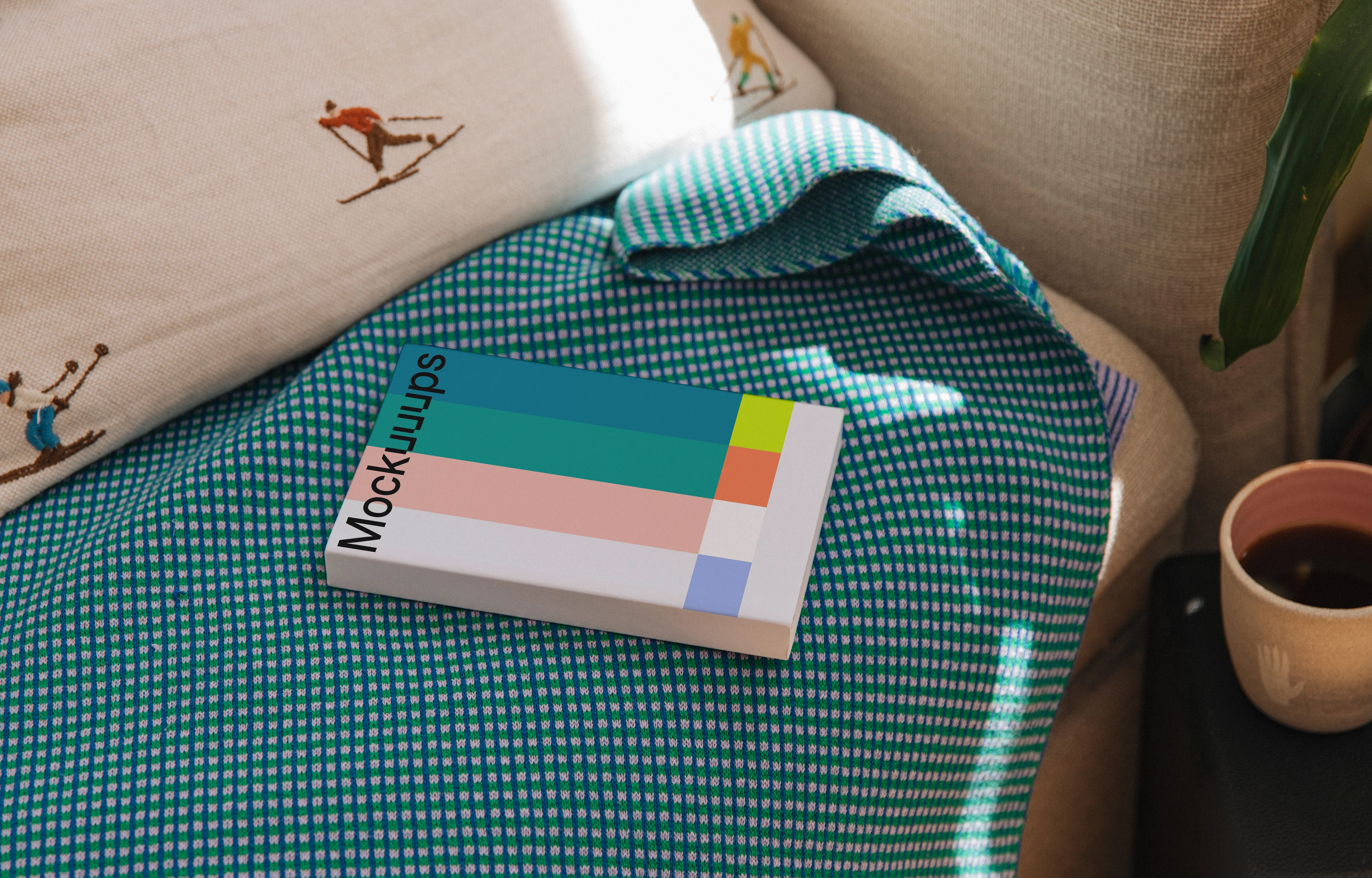 Softcover book mockup on a cozy fabric setting