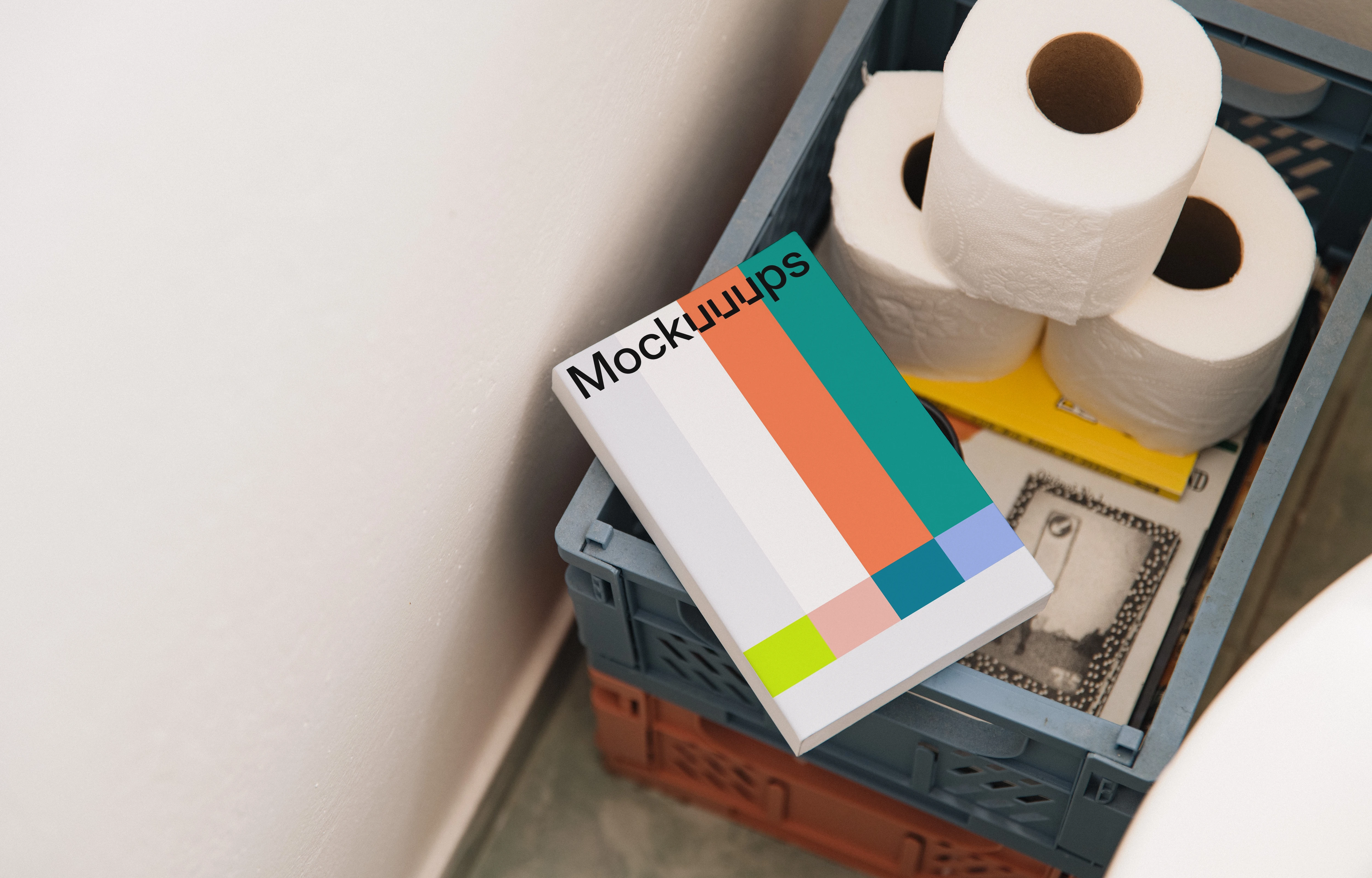 Softcover book mockup on a crate with toiletries