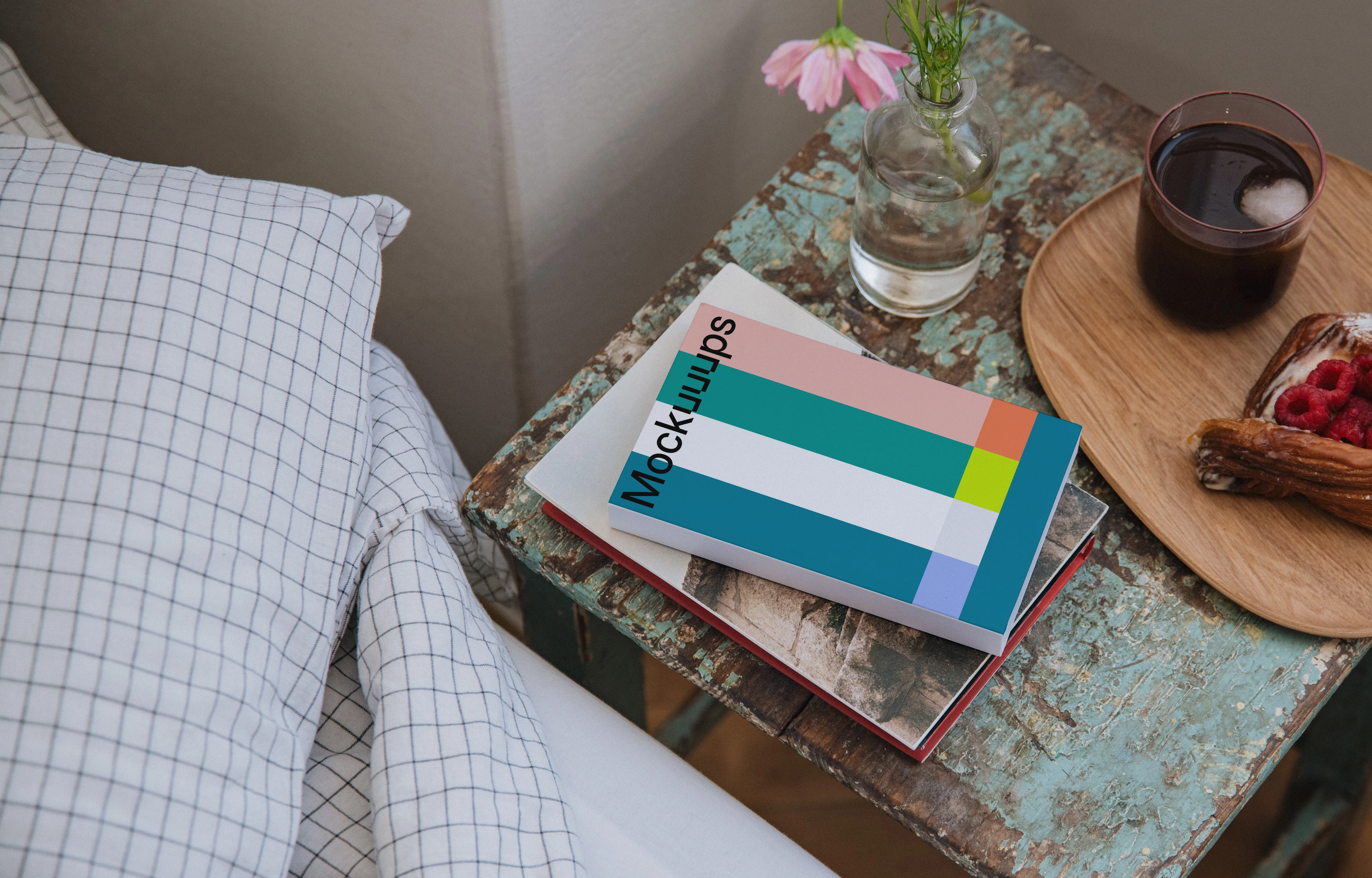 Softcover book mockup on a rustic bedside table