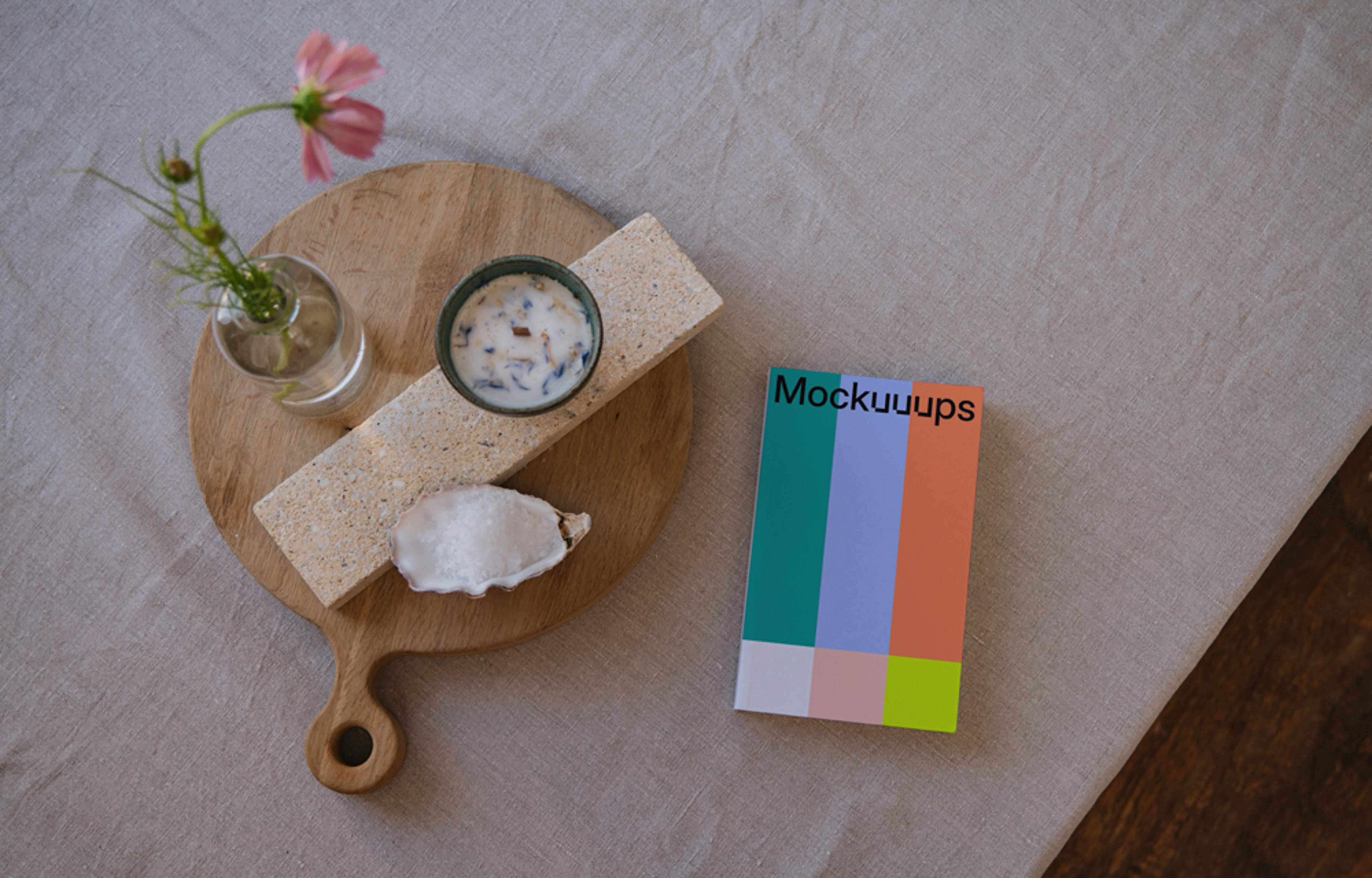 Softcover book mockup on a wooden tray with decor items