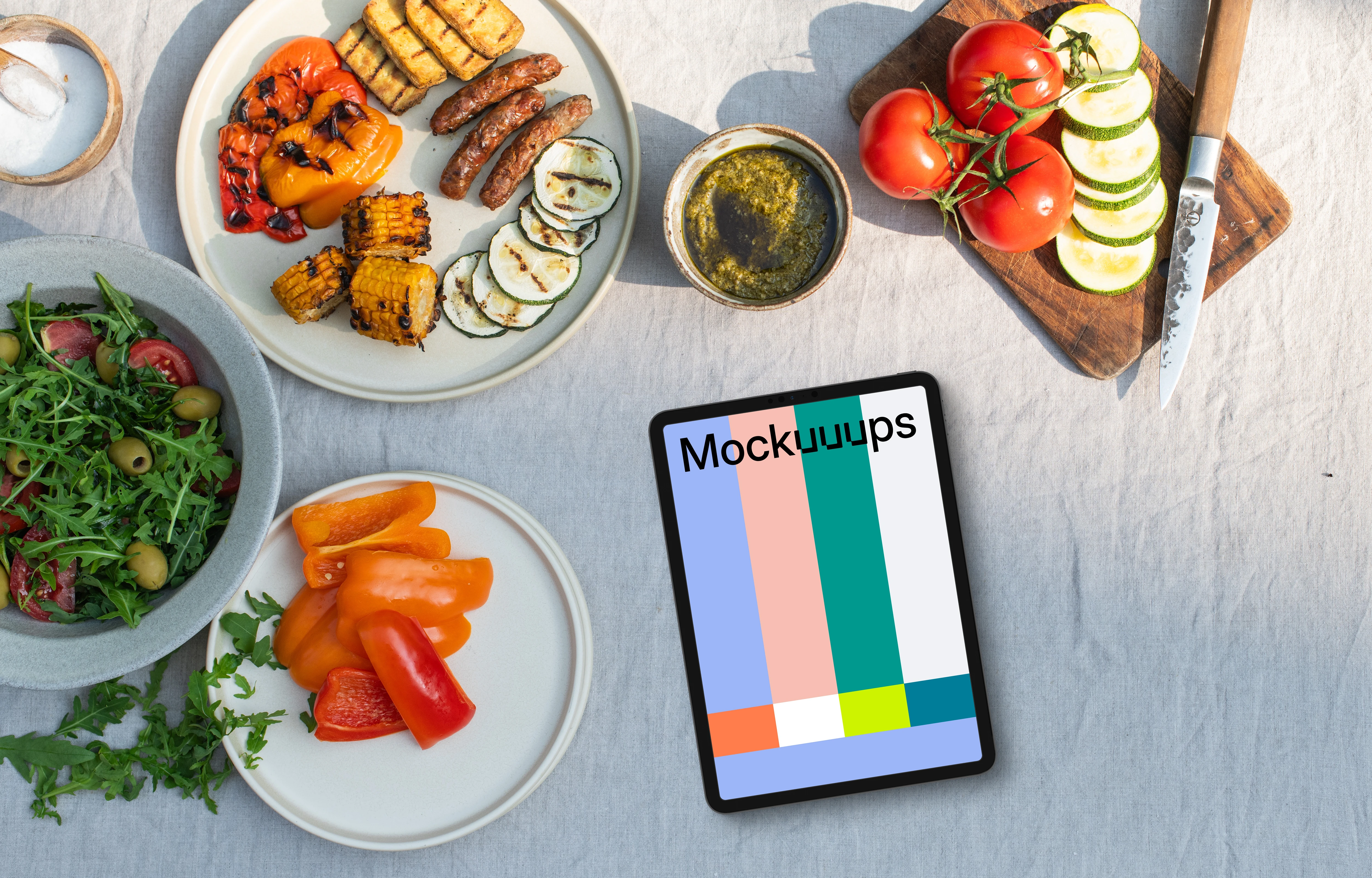 Tablet mockup in the middle of barbecue plates