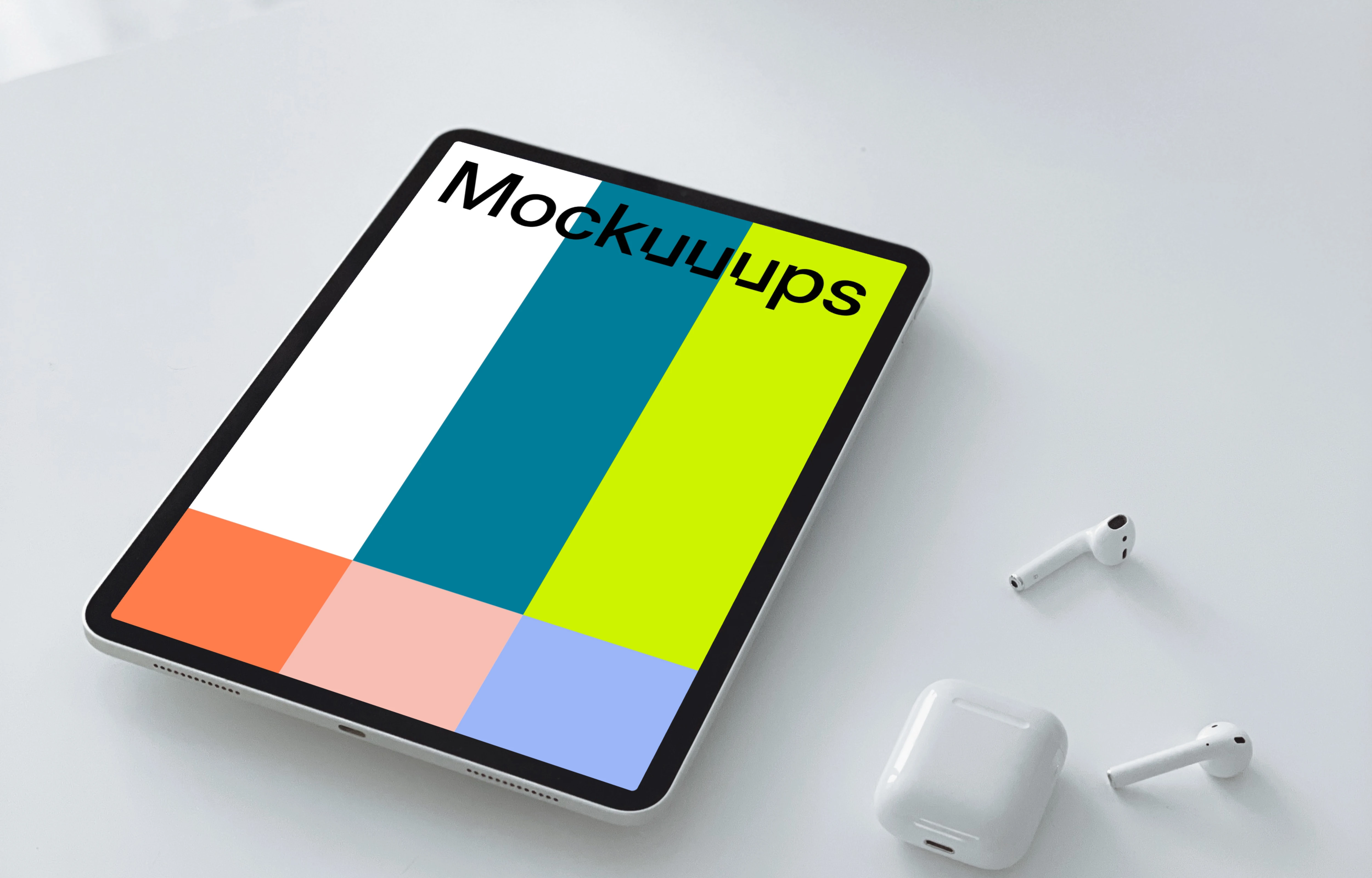Tablet mockup on a table with a pair of Airpods 2 