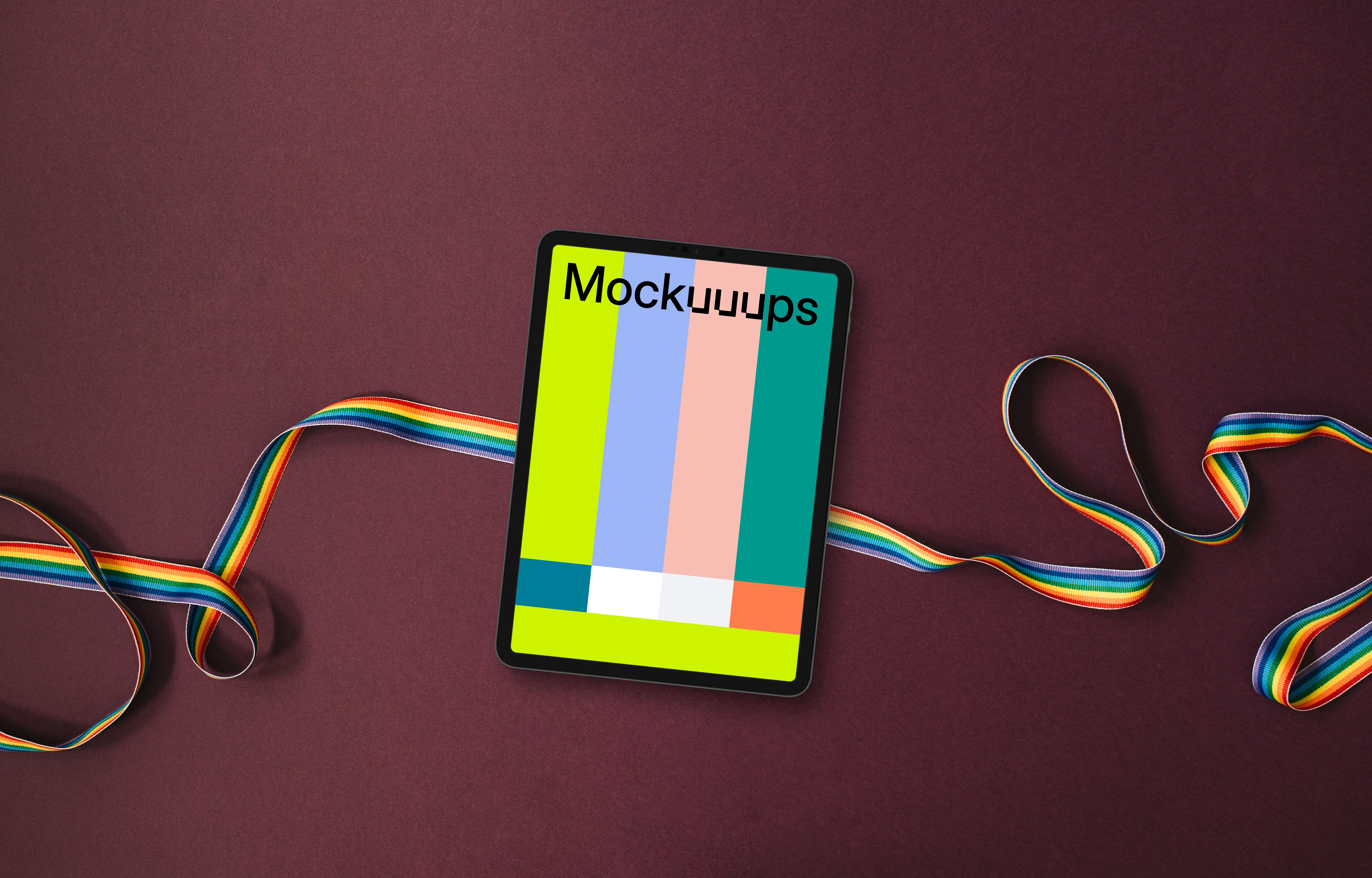Tablet mockup on a twisted rainbow ribbon